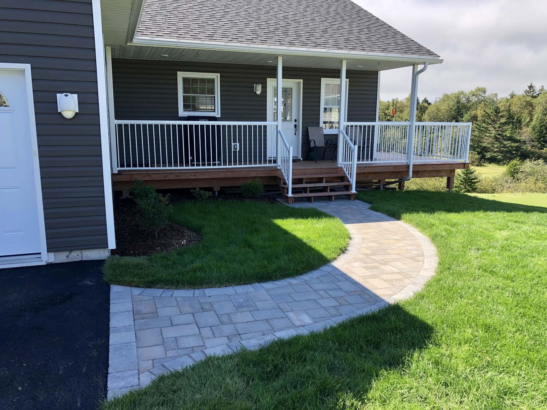 A house with a porch and a walkway leading to it