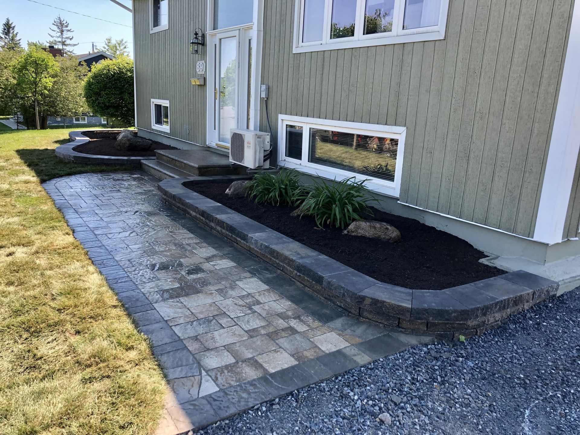 A brick walkway leading to the front door of a house.
