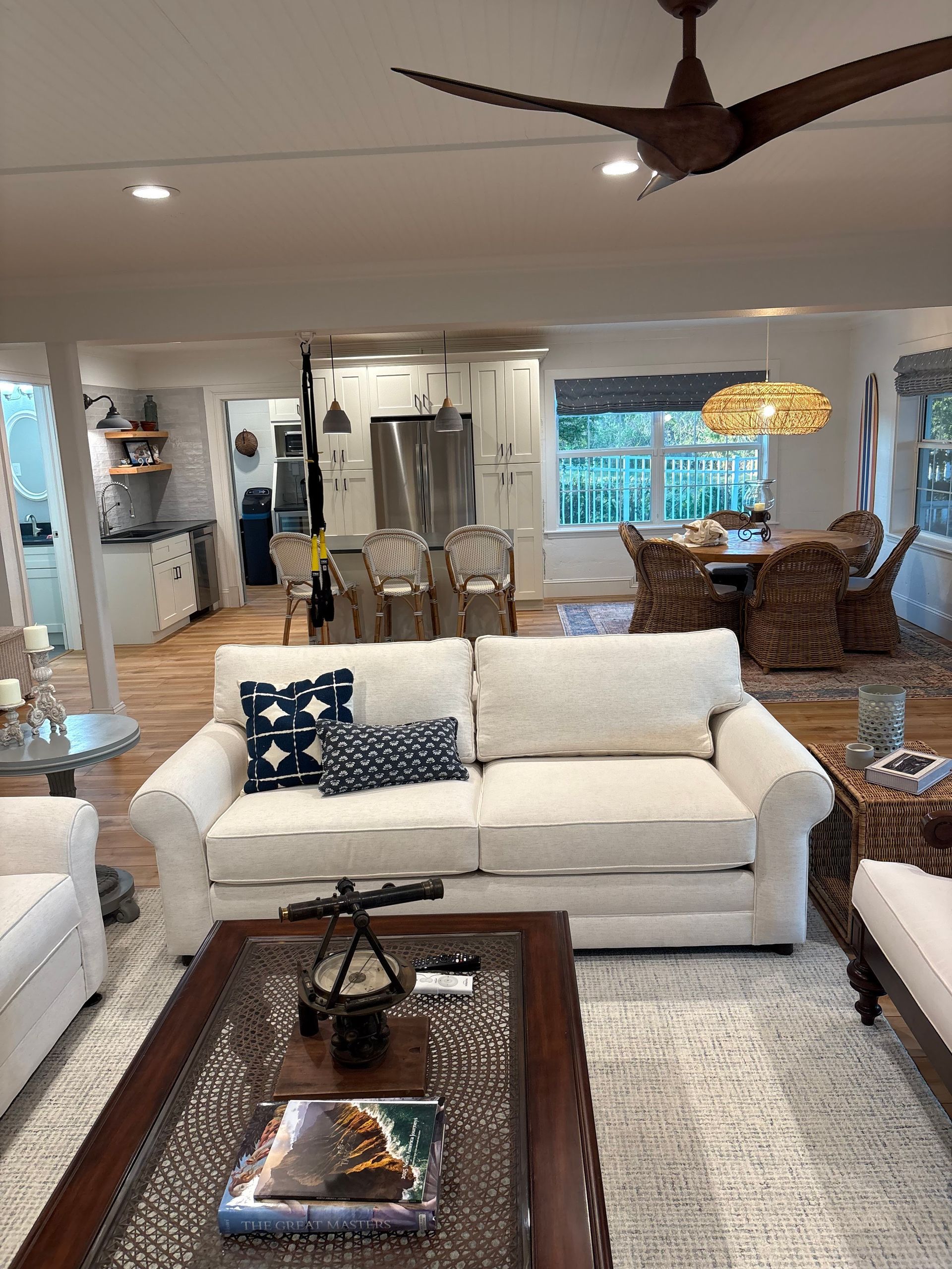 A living room filled with furniture and a ceiling fan.