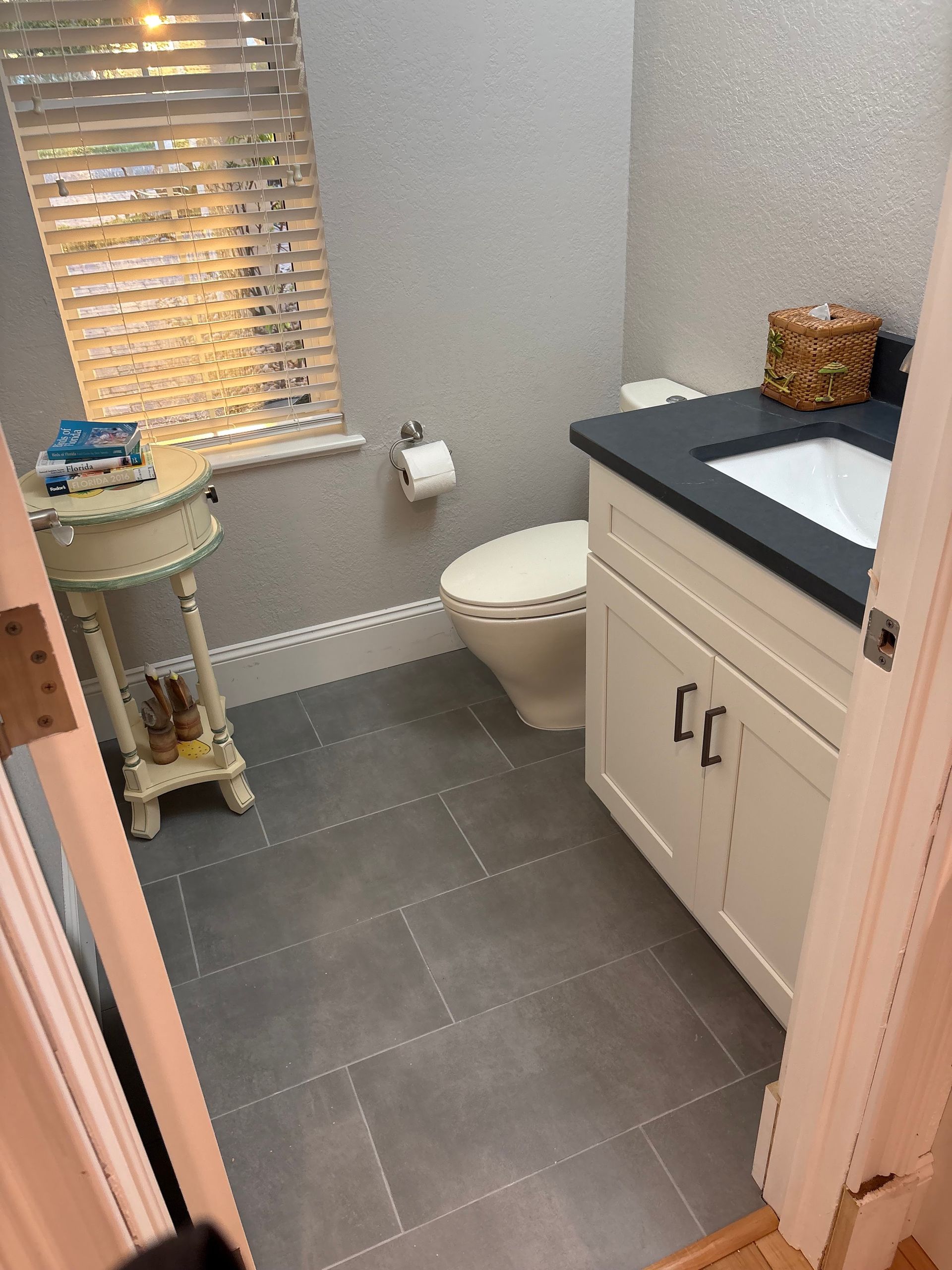 A bathroom with a toilet a sink and a window