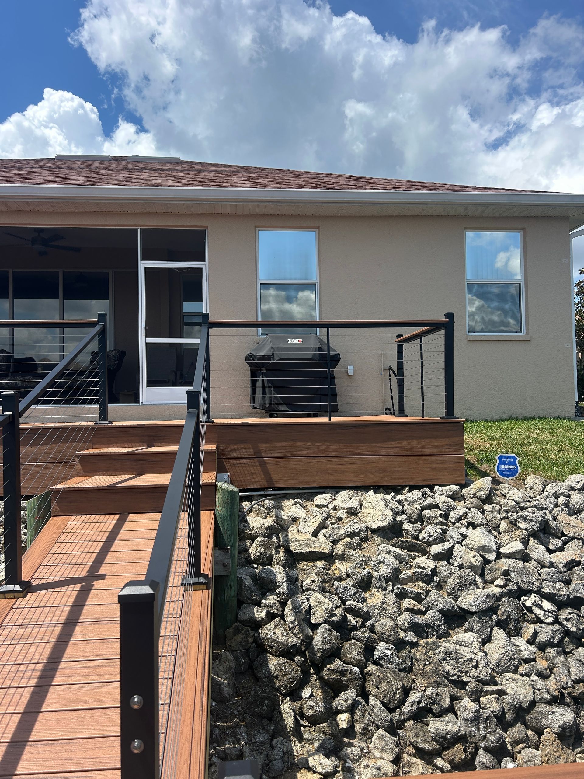 A house with a wooden deck and stairs leading up to it