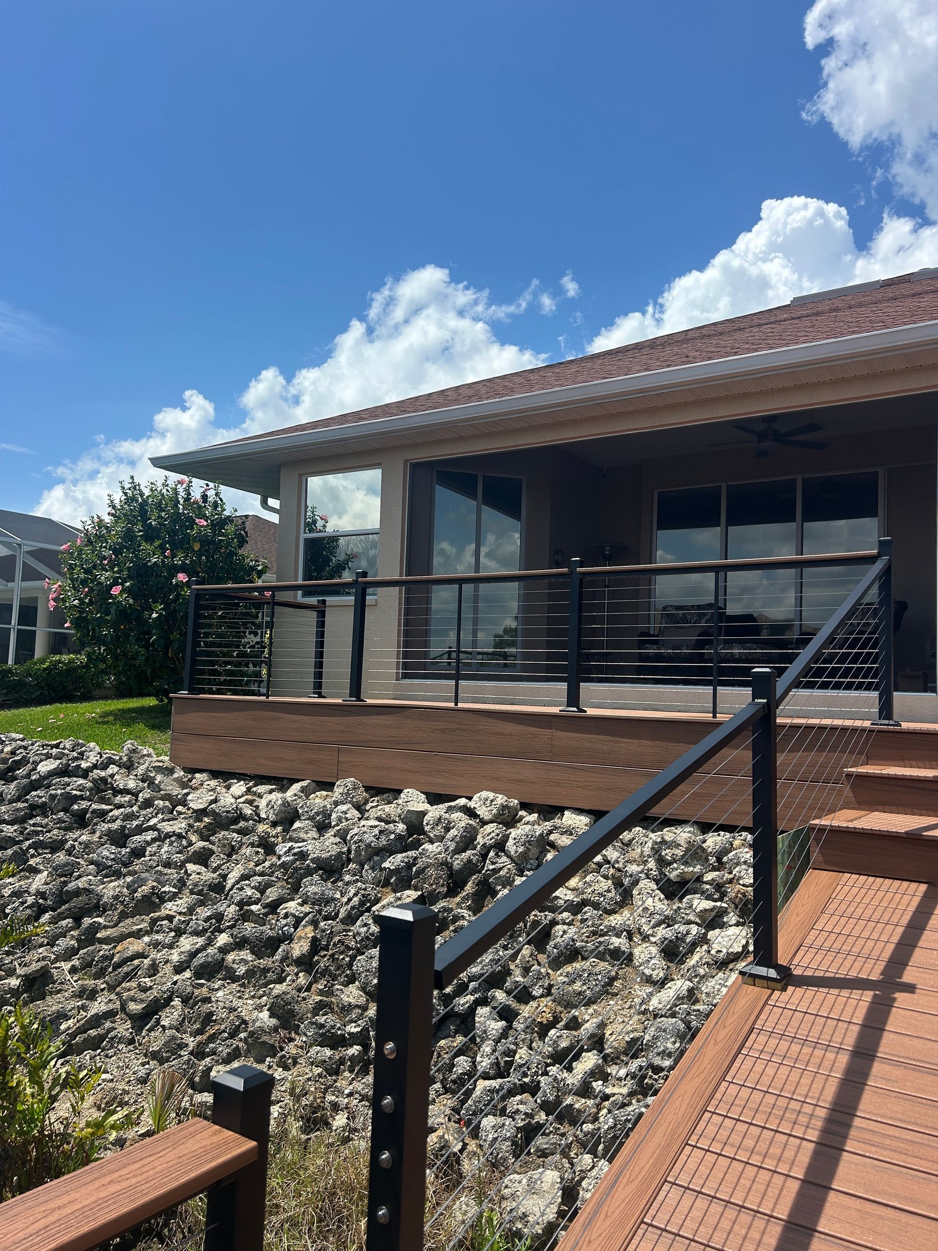 A house with a deck and stairs leading up to it