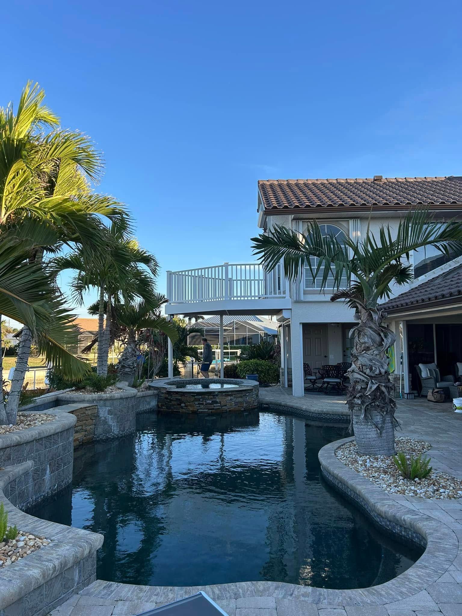 A large house with a large pond in front of it.
