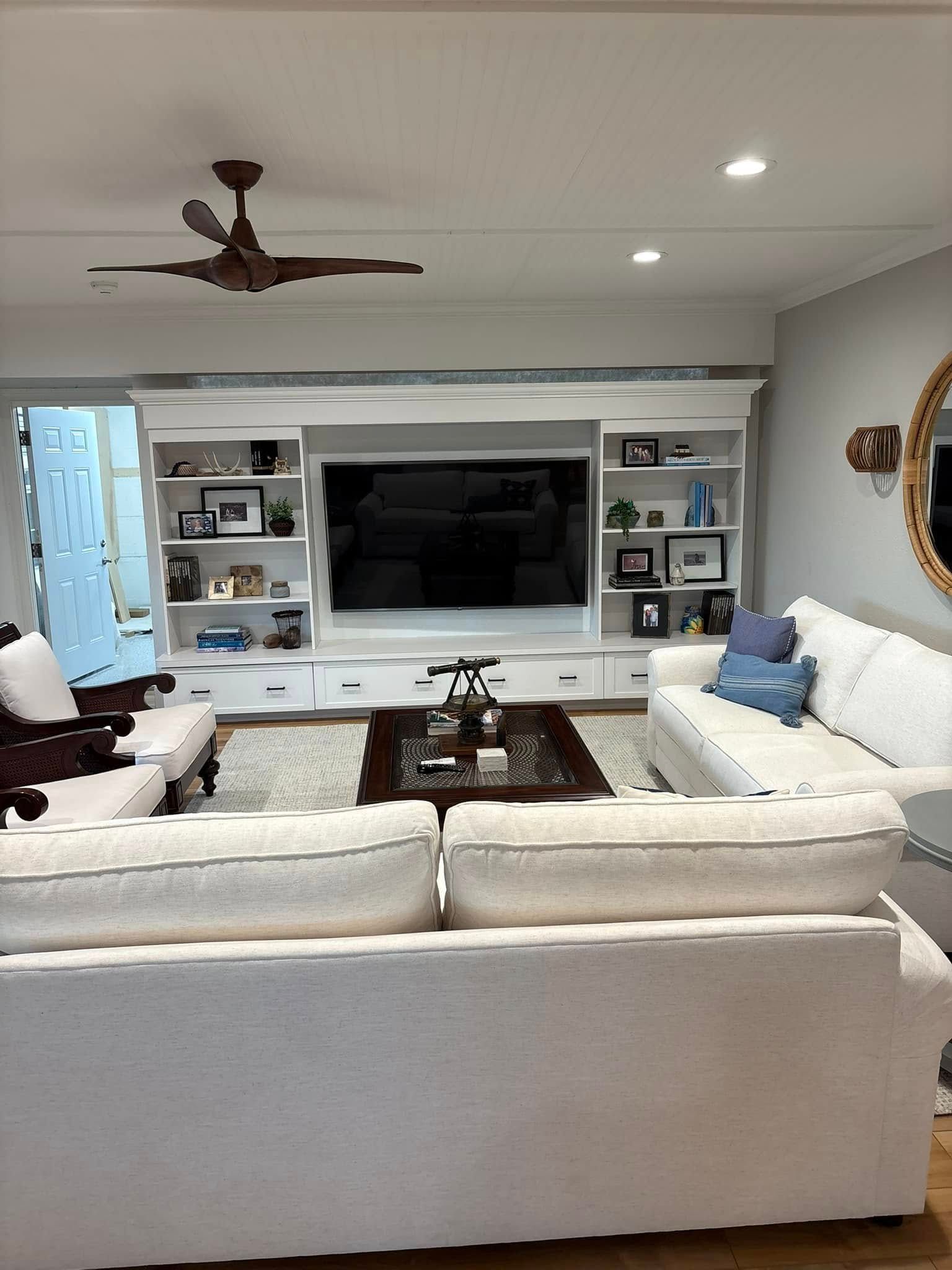 A living room filled with furniture and a flat screen tv.