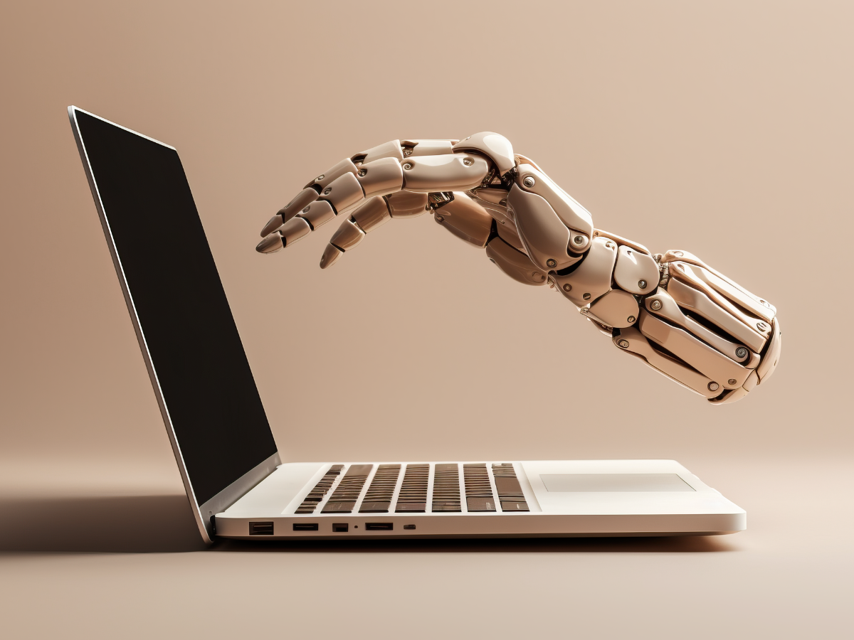 A robotic hand is reaching out from a laptop computer. A robotic hand is reaching out from a laptop computer.