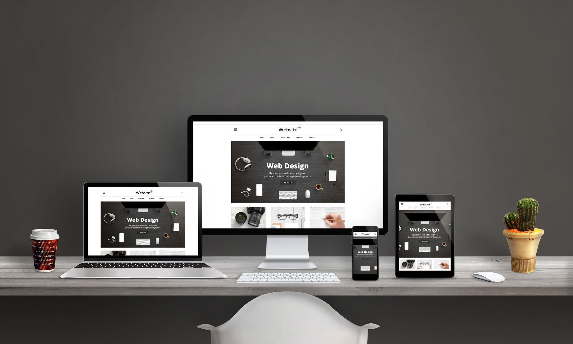 Website mockups on various devices, including a laptop, desktop, tablet, and phone, displayed on a desk.
