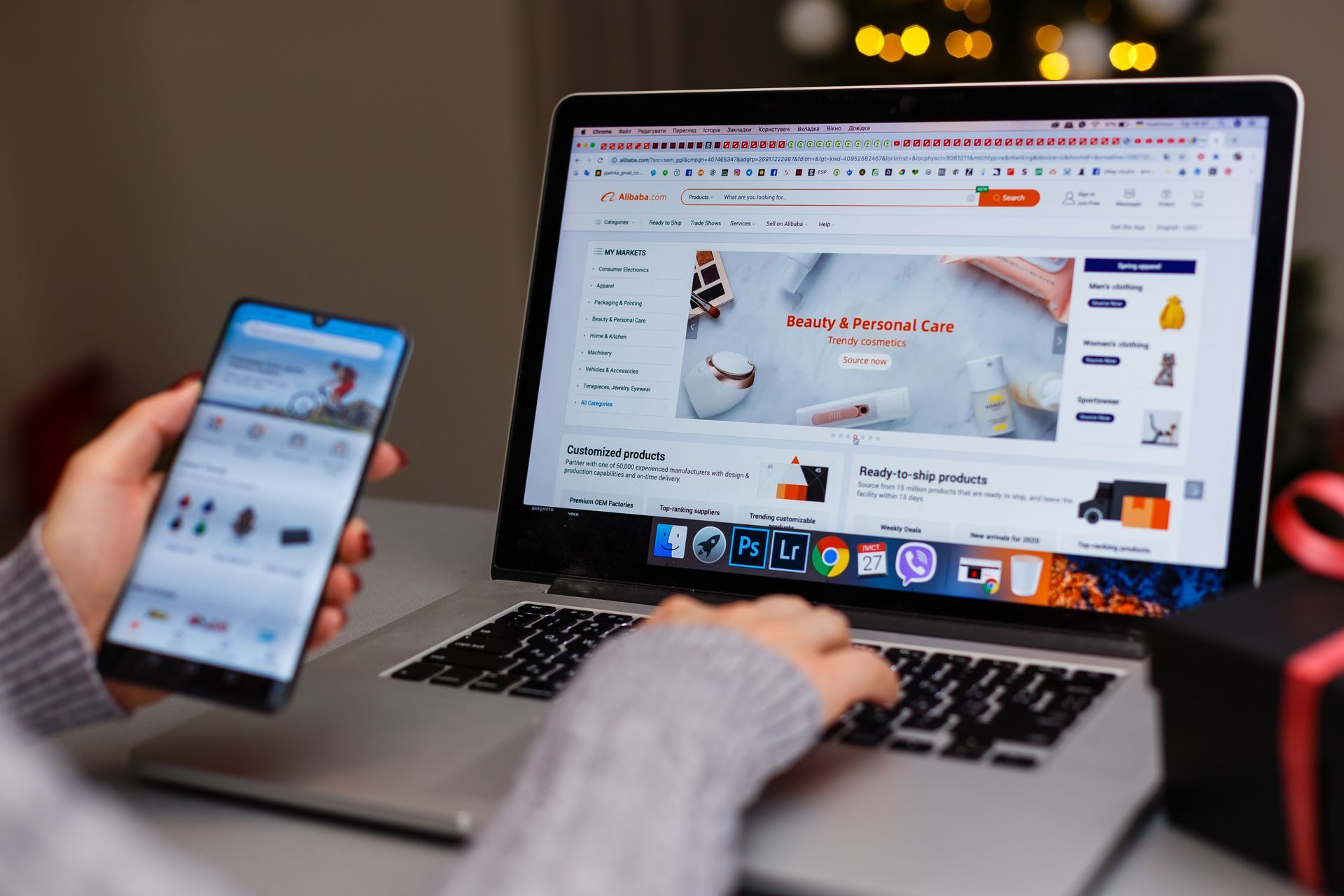 Person using a laptop and smartphone to browse an online store, showcasing product options.