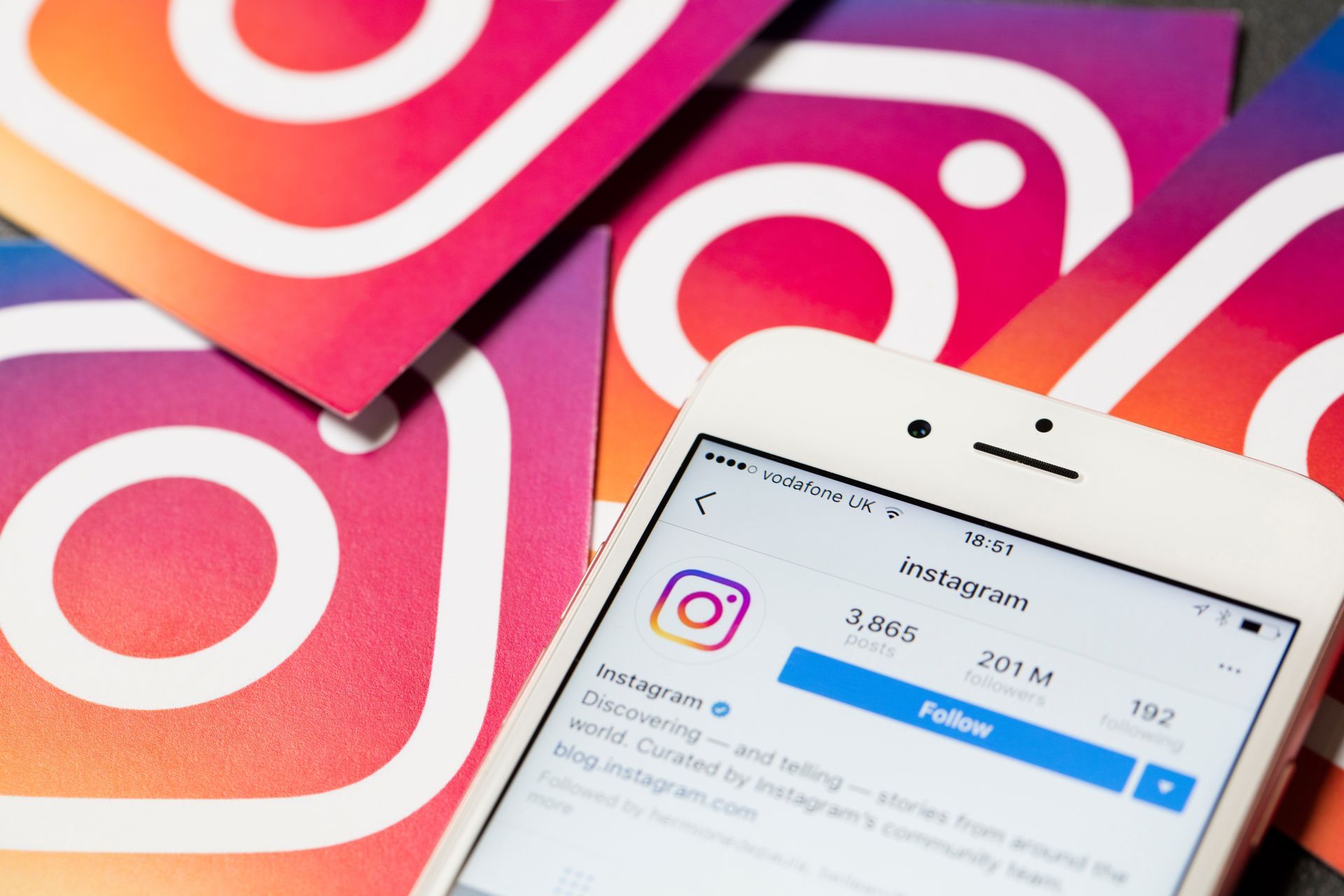 Instagram app displayed on phone with several Instagram logo cards.