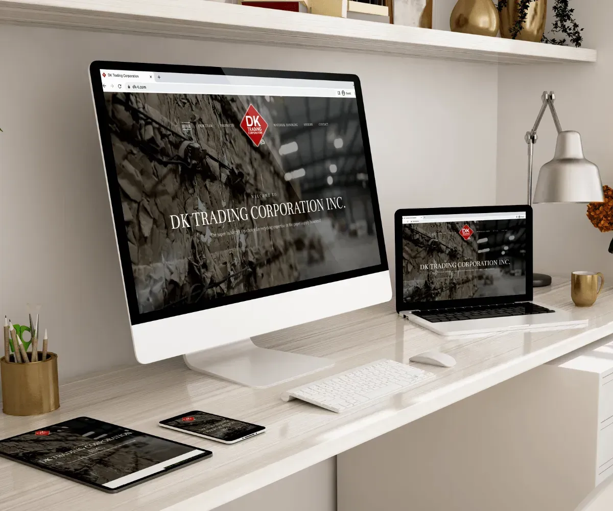 Monitors, laptop, tablet, and smartphone displaying a website on a desk.