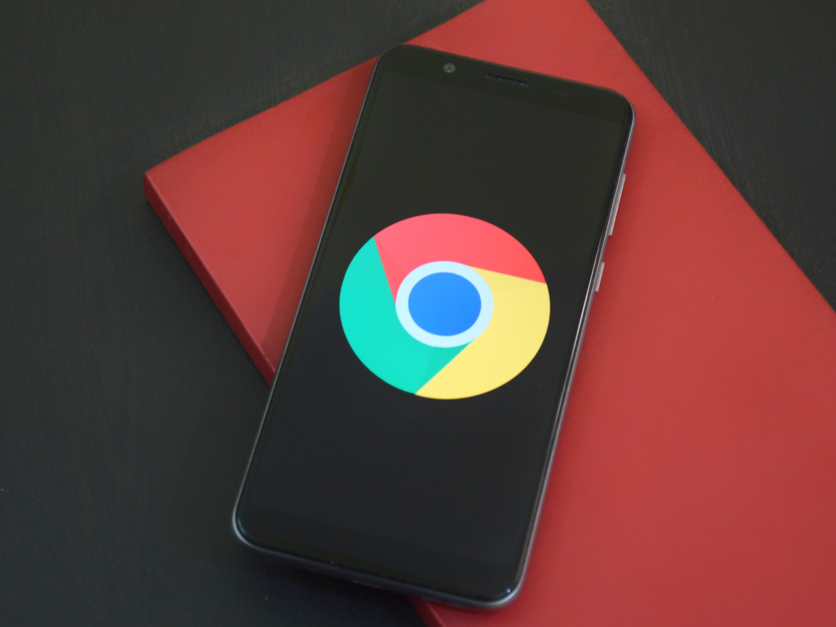 A cell phone with a google chrome logo on the screen