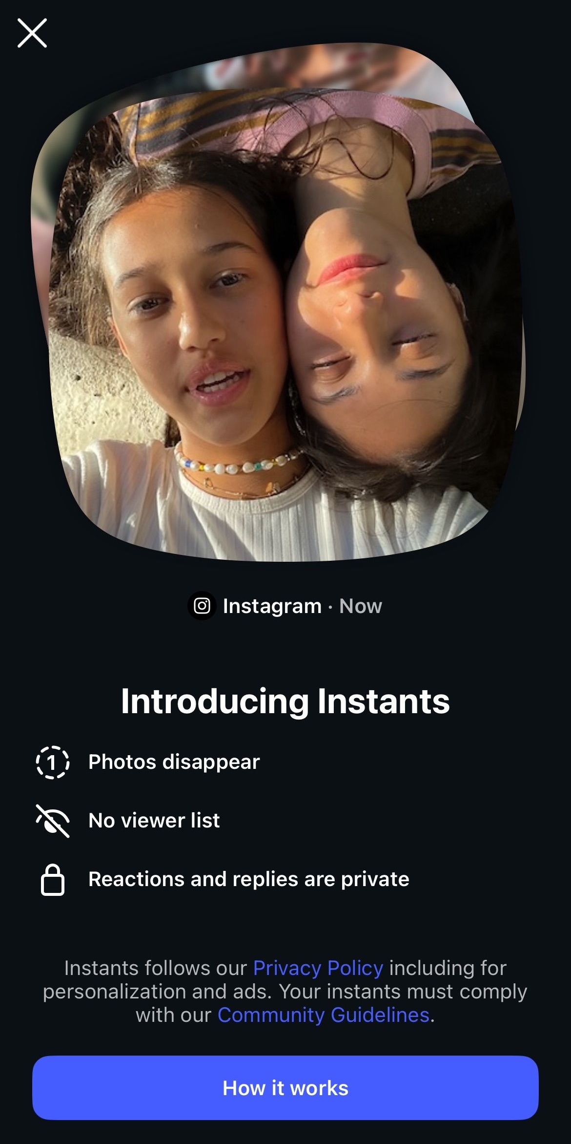 Dark app screen showing a rounded photo of two people leaning together above a blue “Start now” button. Dark app screen showing a rounded photo of two people leaning together above a blue “Start now” button.