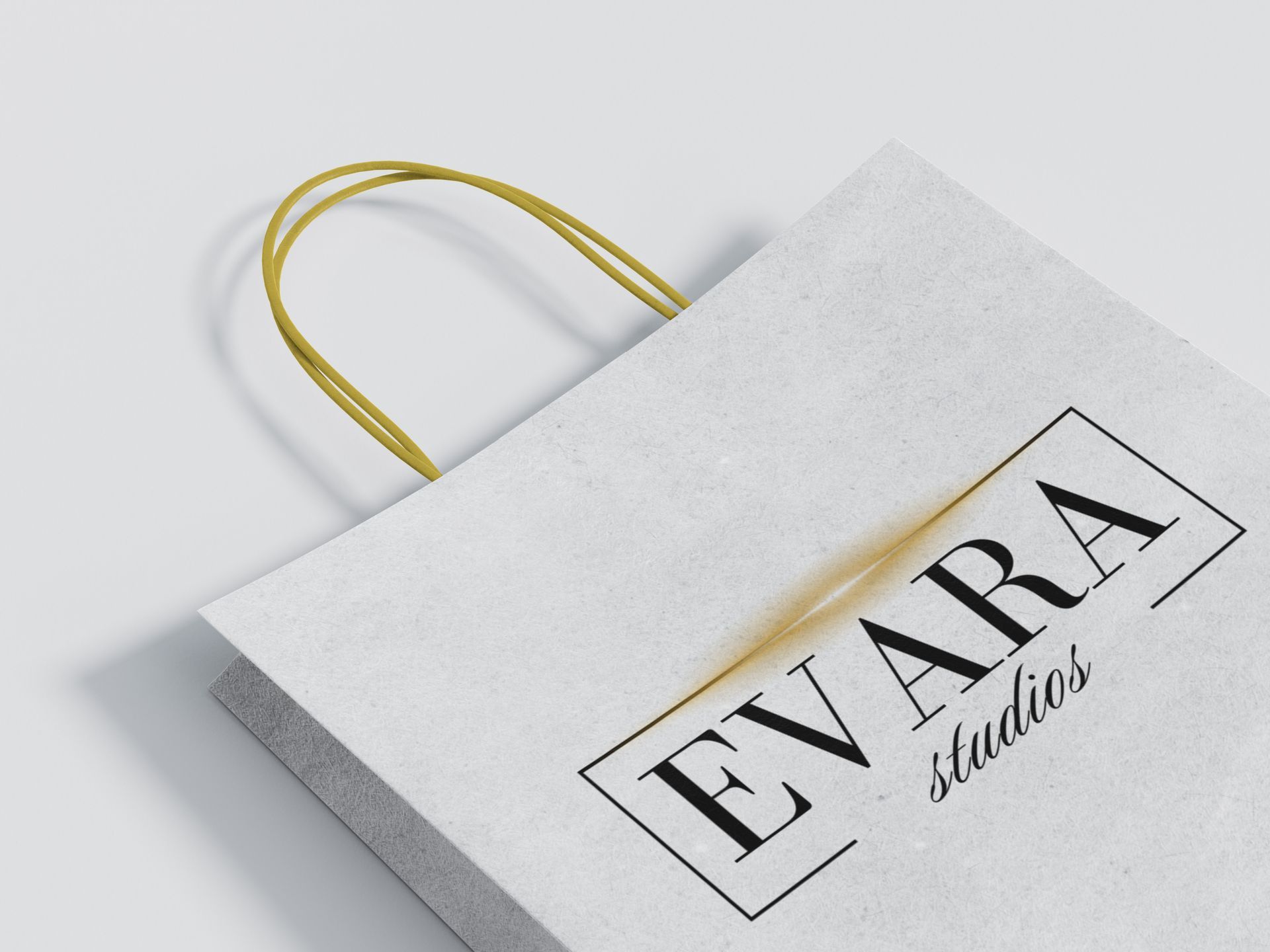 A bottle of mascara , brushes , pencils and a palm leaf on a table.