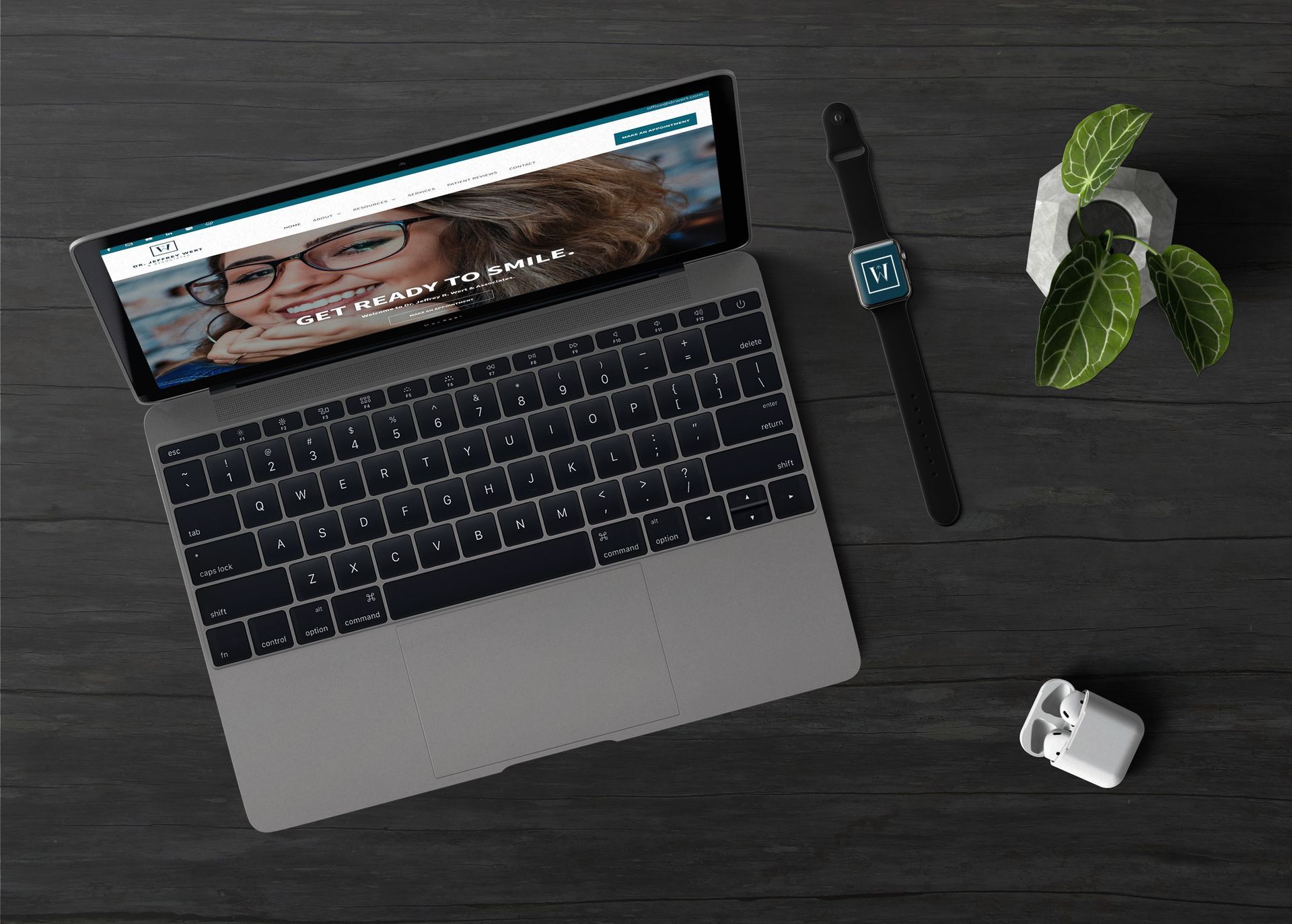 A laptop computer is open to a website on a wooden table.
