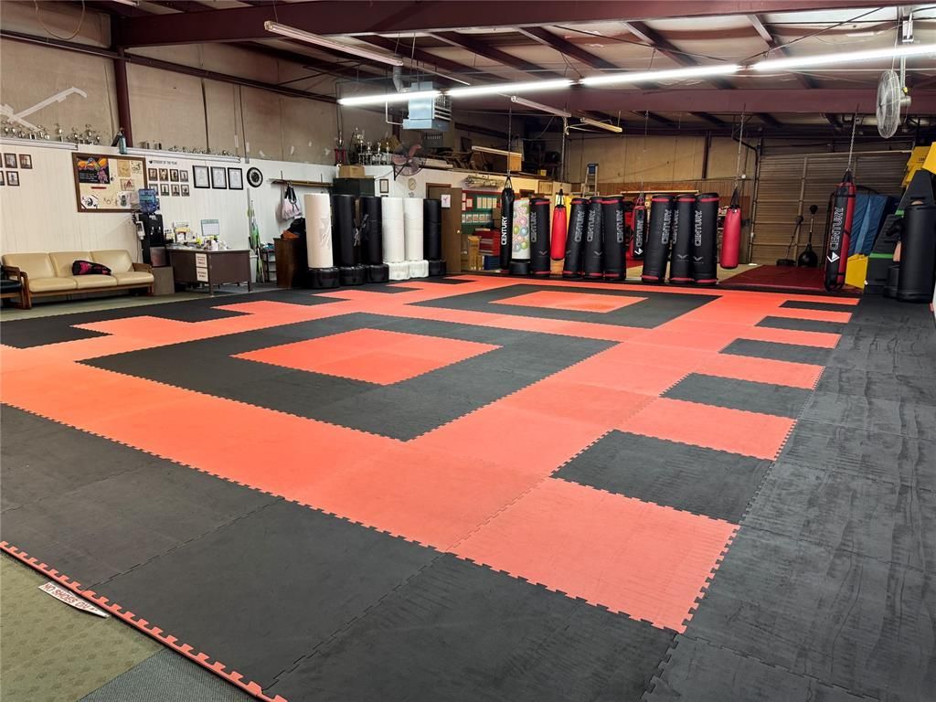 There is a large karate mat in the middle of the room.