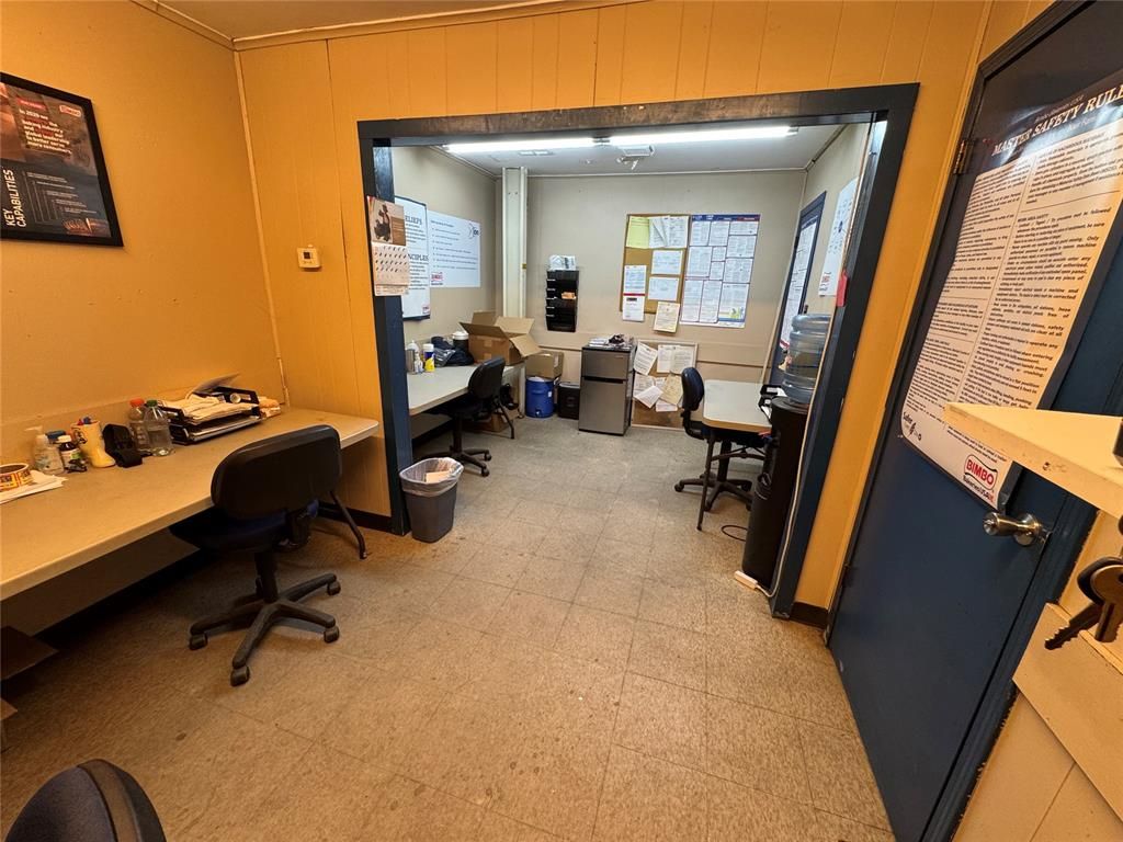 A room with a lot of desks and chairs in it.