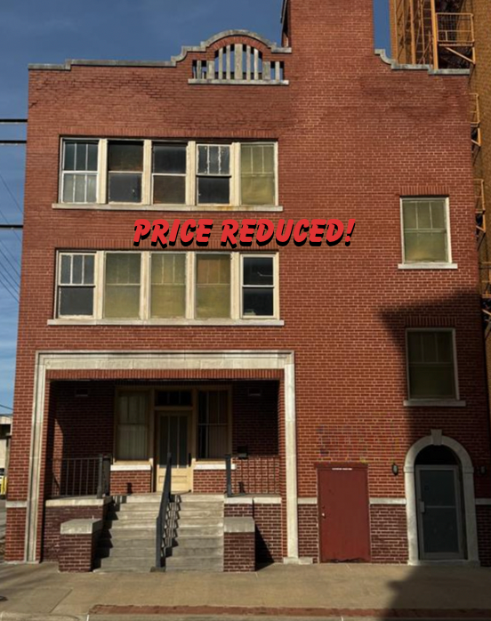 A brick building with the words price reduced on it