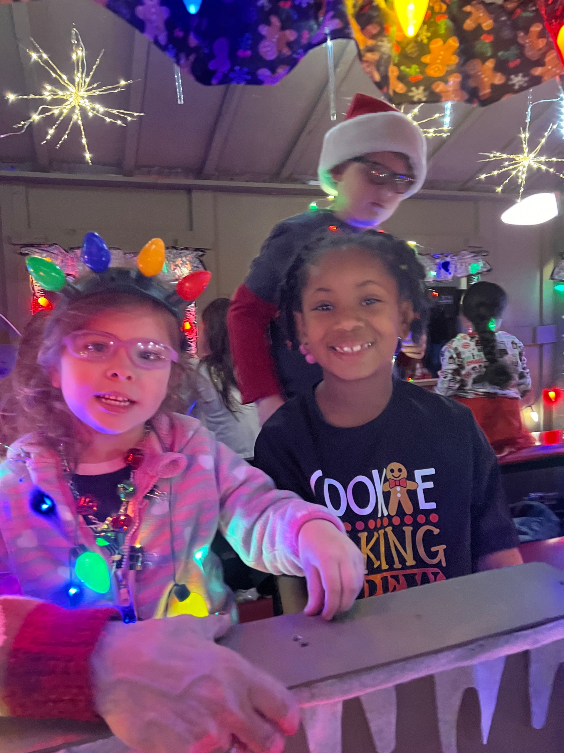 A group of children are posing for a picture in a room decorated for christmas.