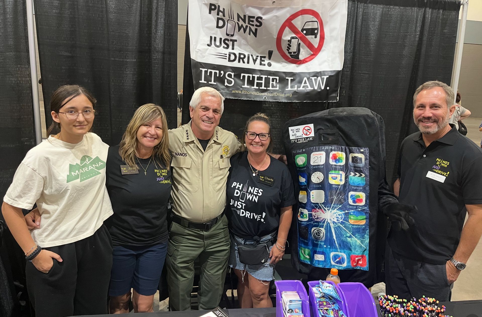 Five people at a booth with