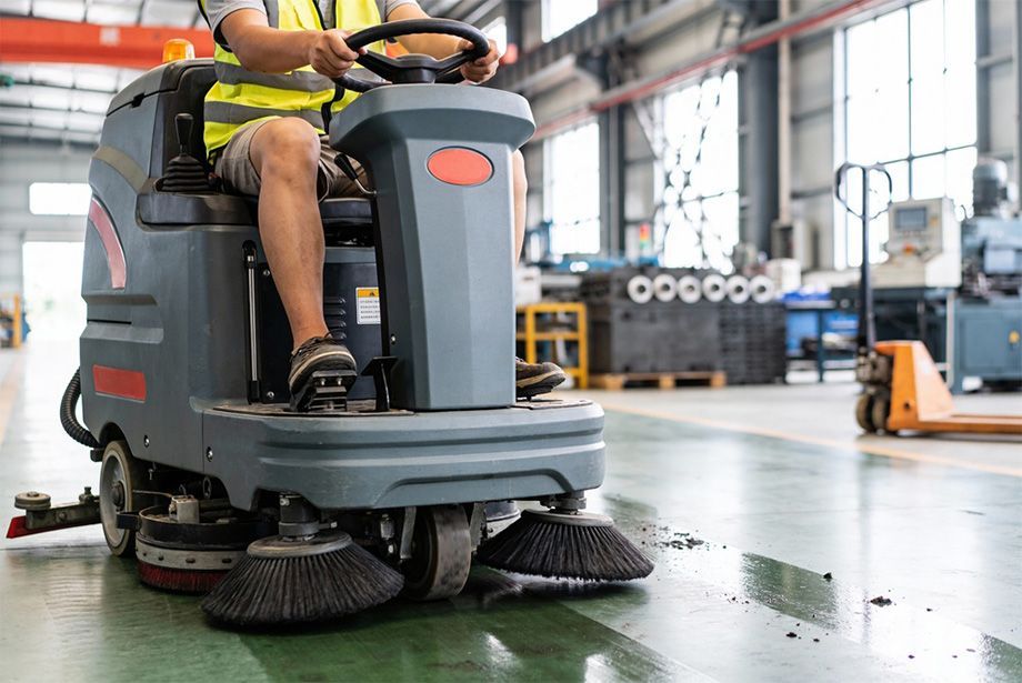Wooden swing set and playhouse on a grassy lawn with trees in the background.