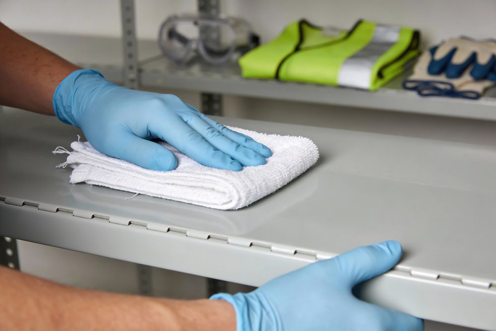Person kneeling, using a drill to install composite deck boards.