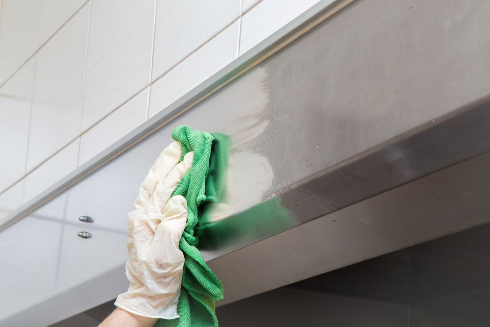 Person kneeling, using a drill to install composite deck boards.