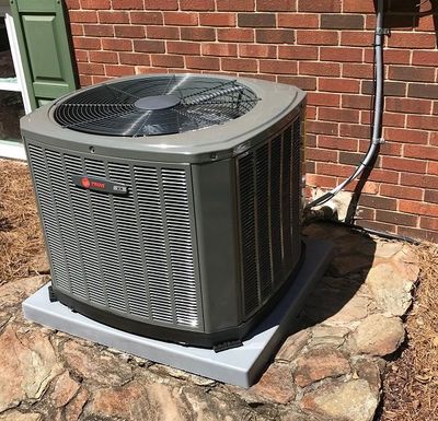 HVAC Contractor — Man Repairing The AC in  Winston-Salem, NC