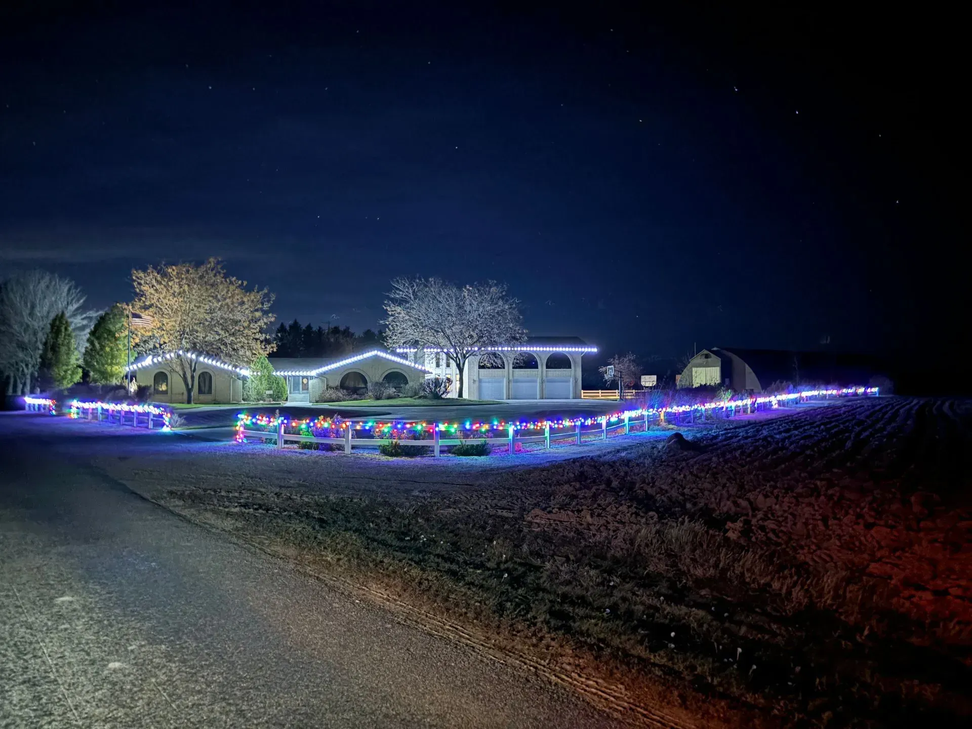 A house is decorated with christmas lights at night.