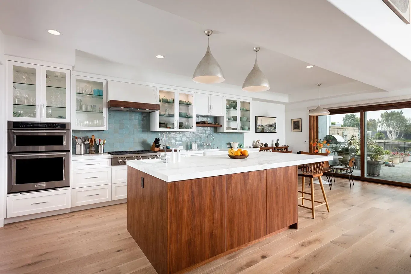 A kitchen with a large wooden island in the middle of it.