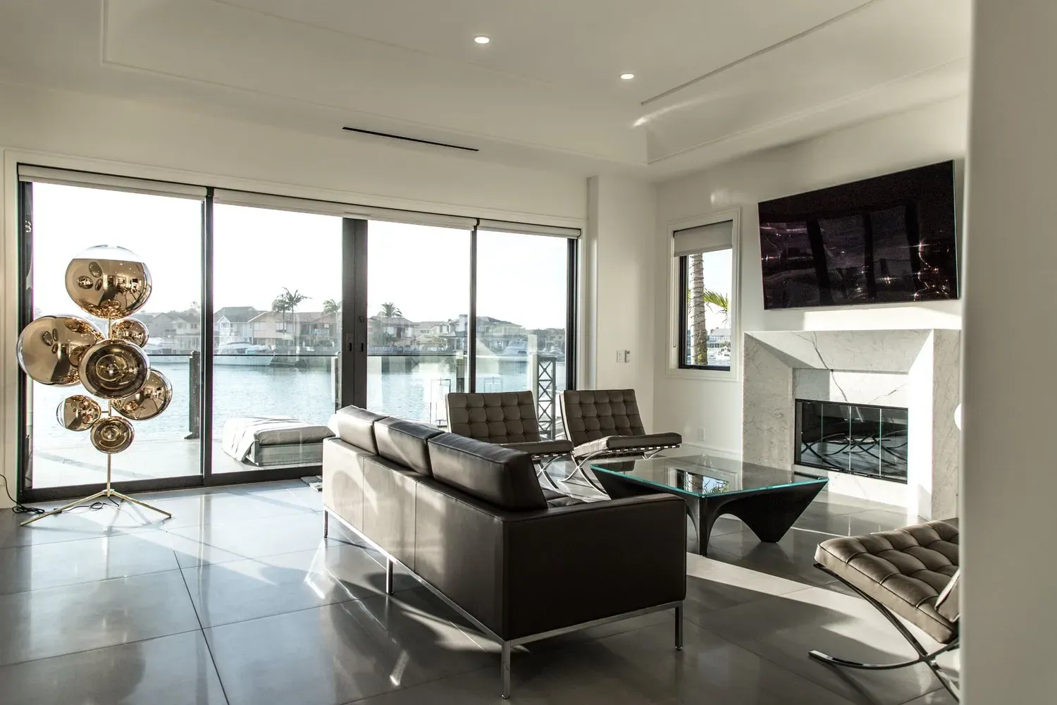 A living room with a couch , chairs , coffee table and television.