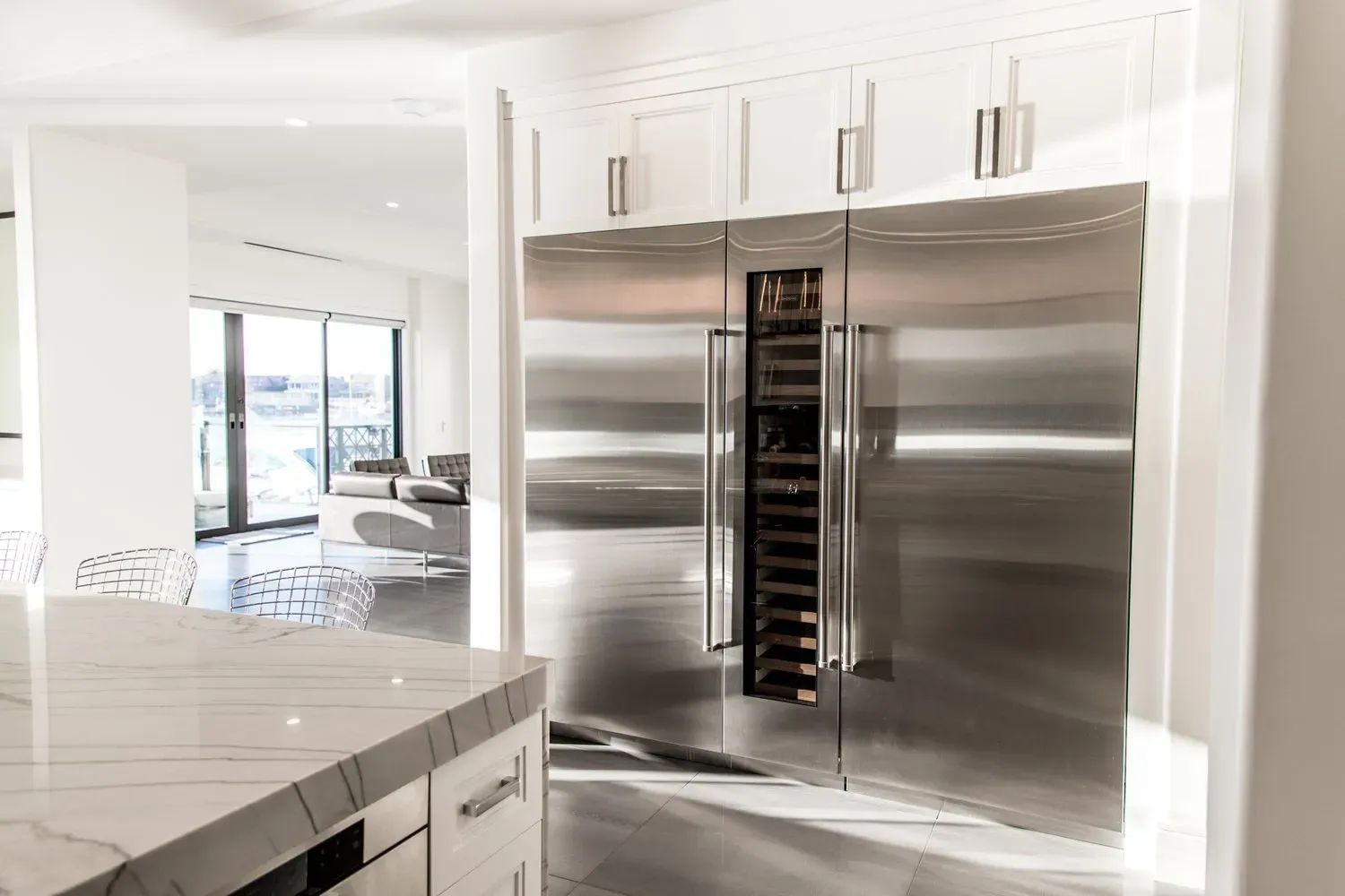 A kitchen with a stainless steel refrigerator and a wine cooler.