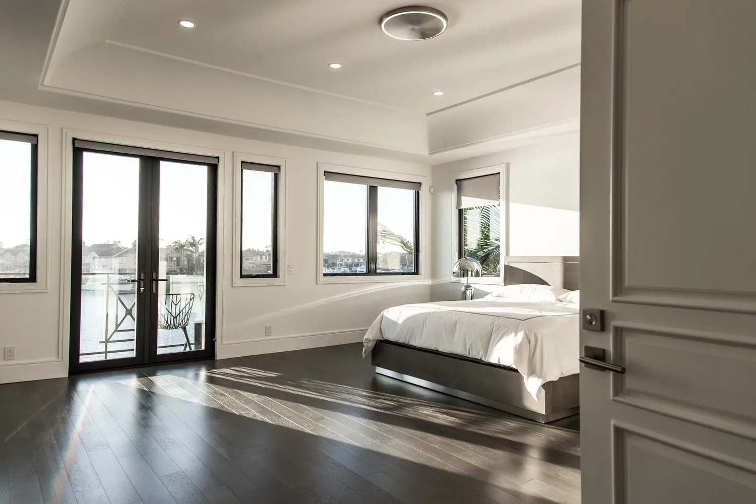 A bedroom with a bed , sliding glass doors , and a balcony.