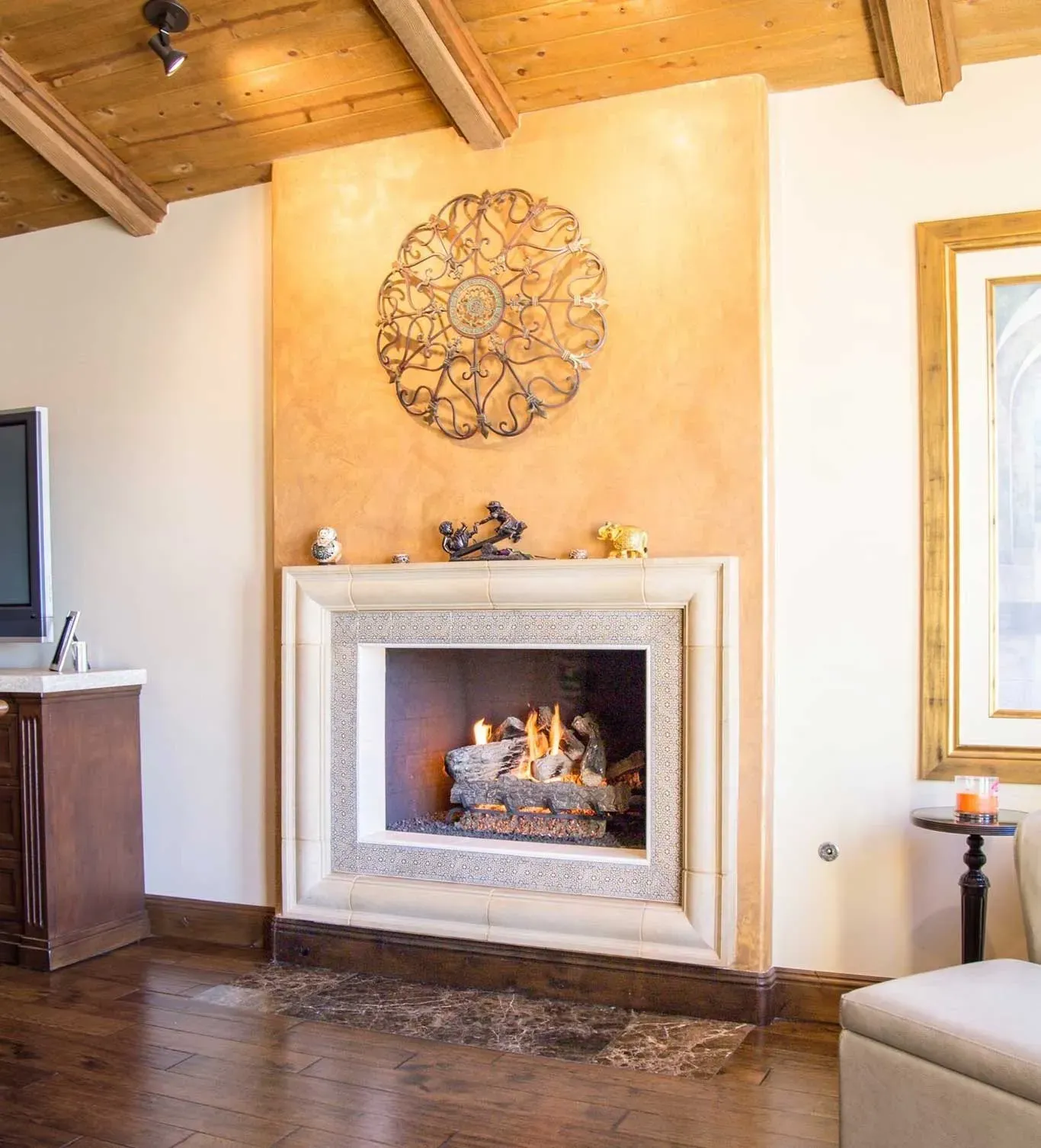 A living room with a fireplace and a television.