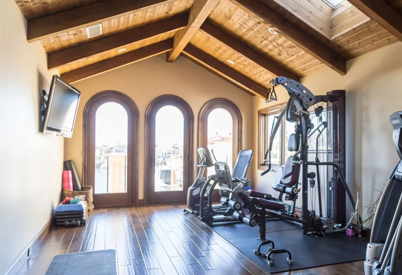 A large room with a lot of exercise equipment in it.