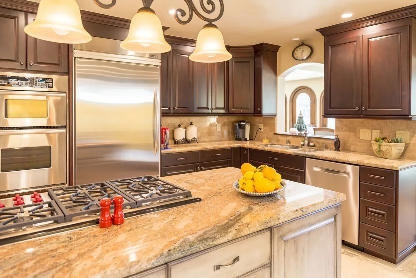 A kitchen with stainless steel appliances and granite counter tops.
