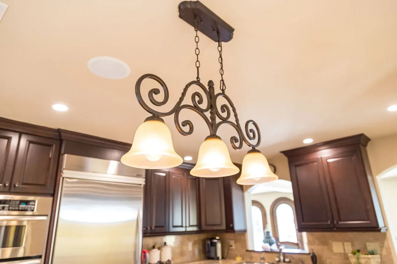 A kitchen with a chandelier hanging from the ceiling