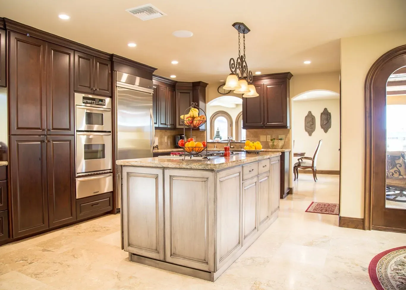A kitchen with a large island and stainless steel appliances.