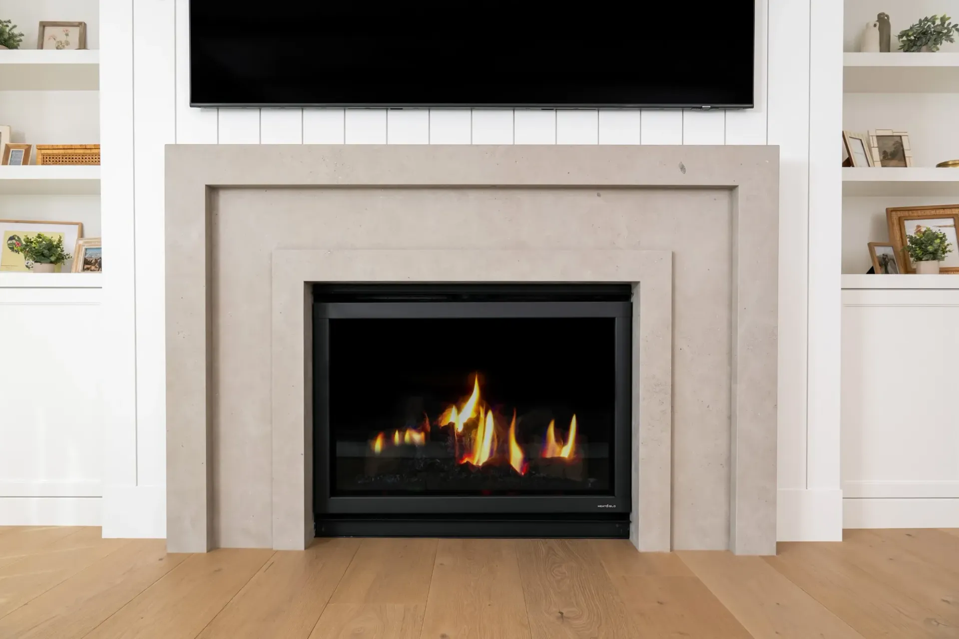 A fireplace with a flat screen tv above it in a living room.