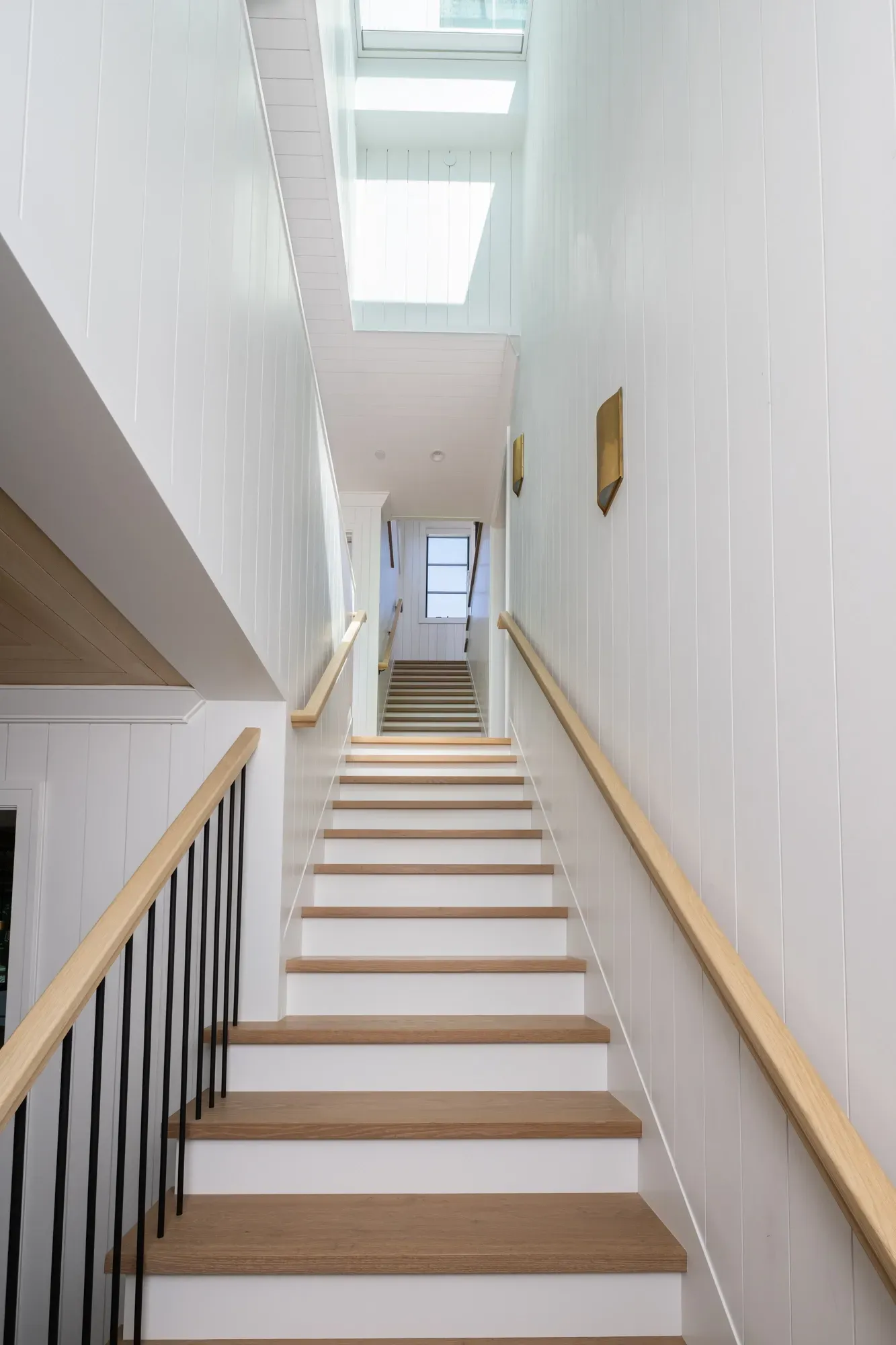 A long hallway with stairs leading up to the second floor.