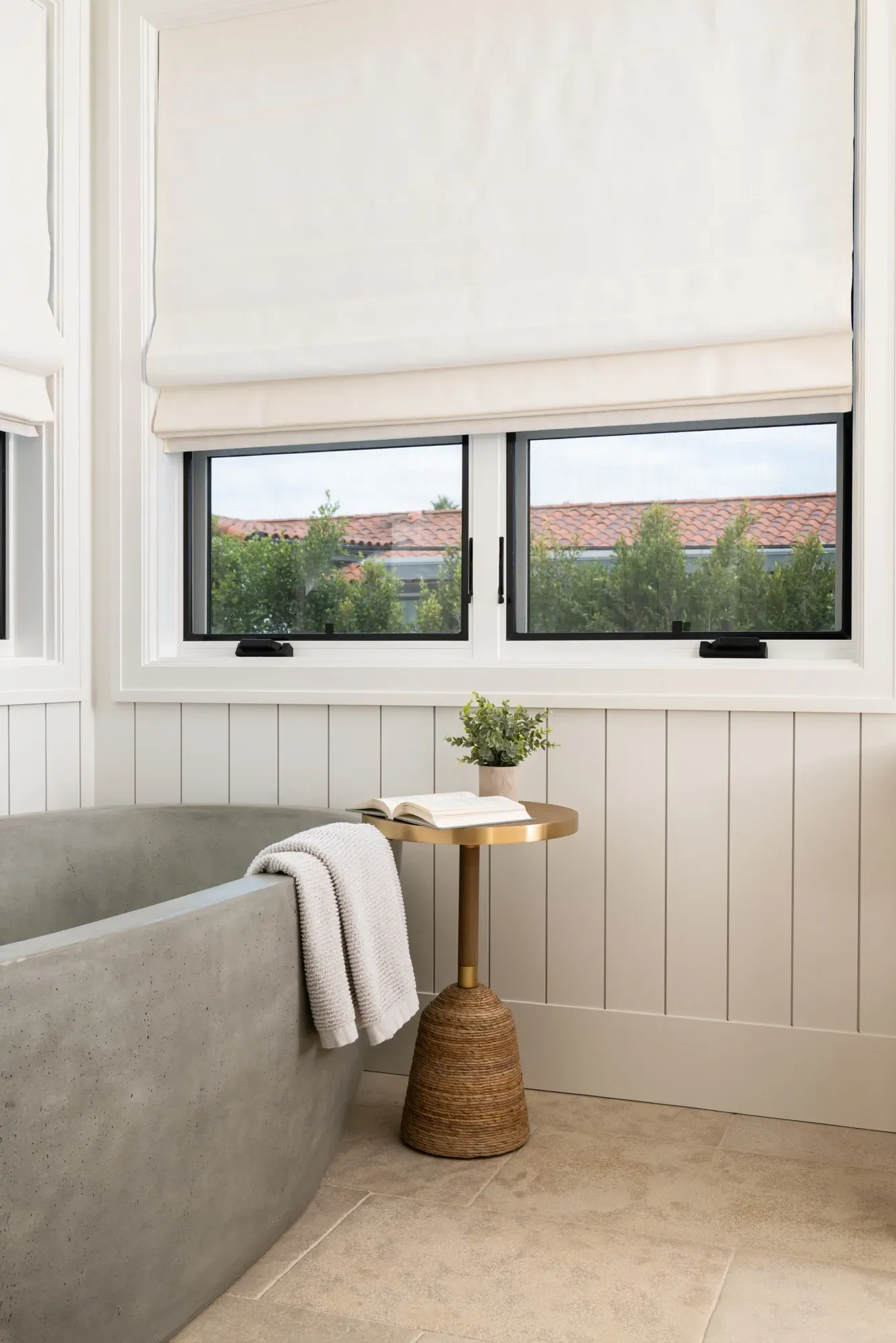 A bathroom with a bathtub and a table next to it.