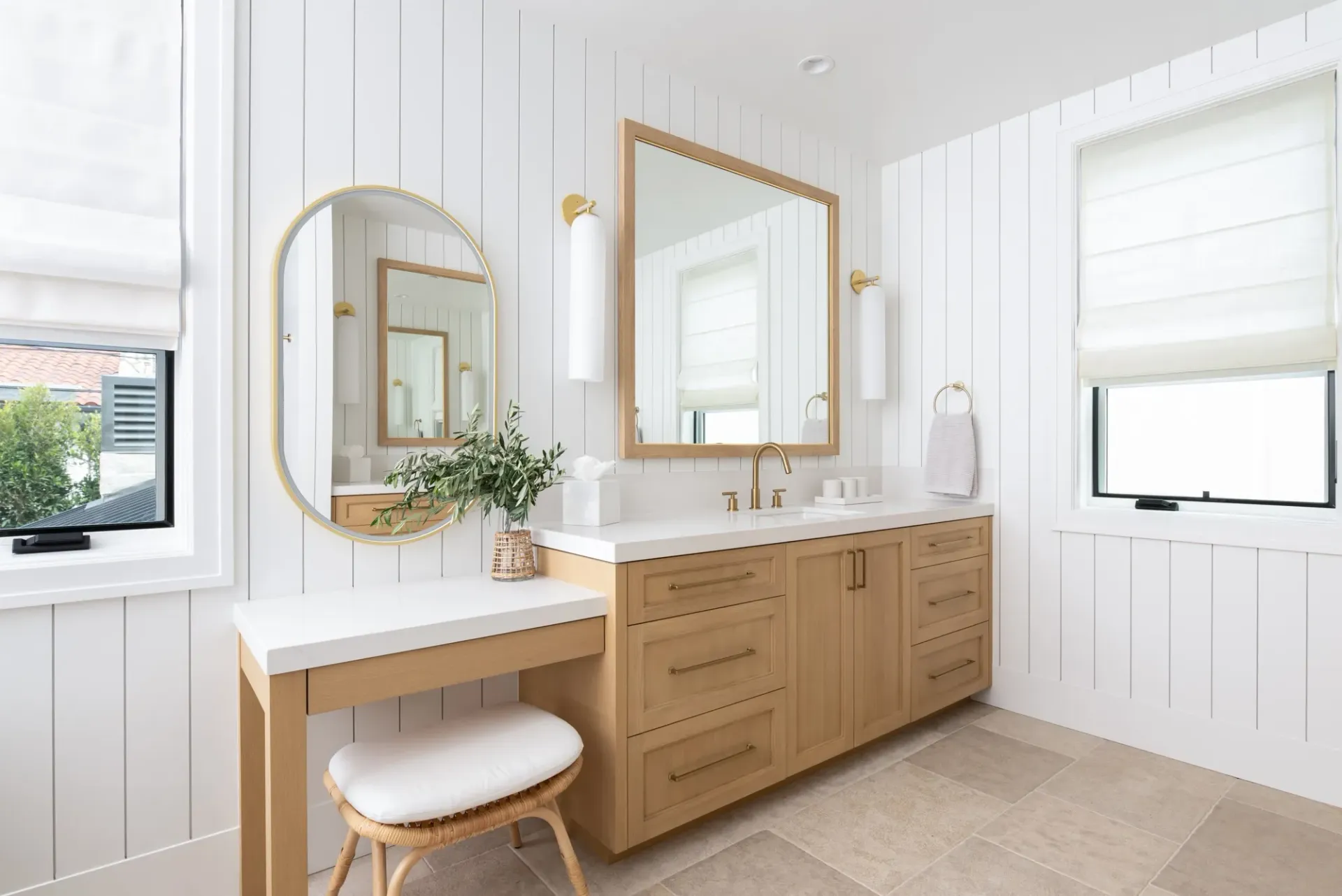 A bathroom with two sinks , a vanity and a mirror.