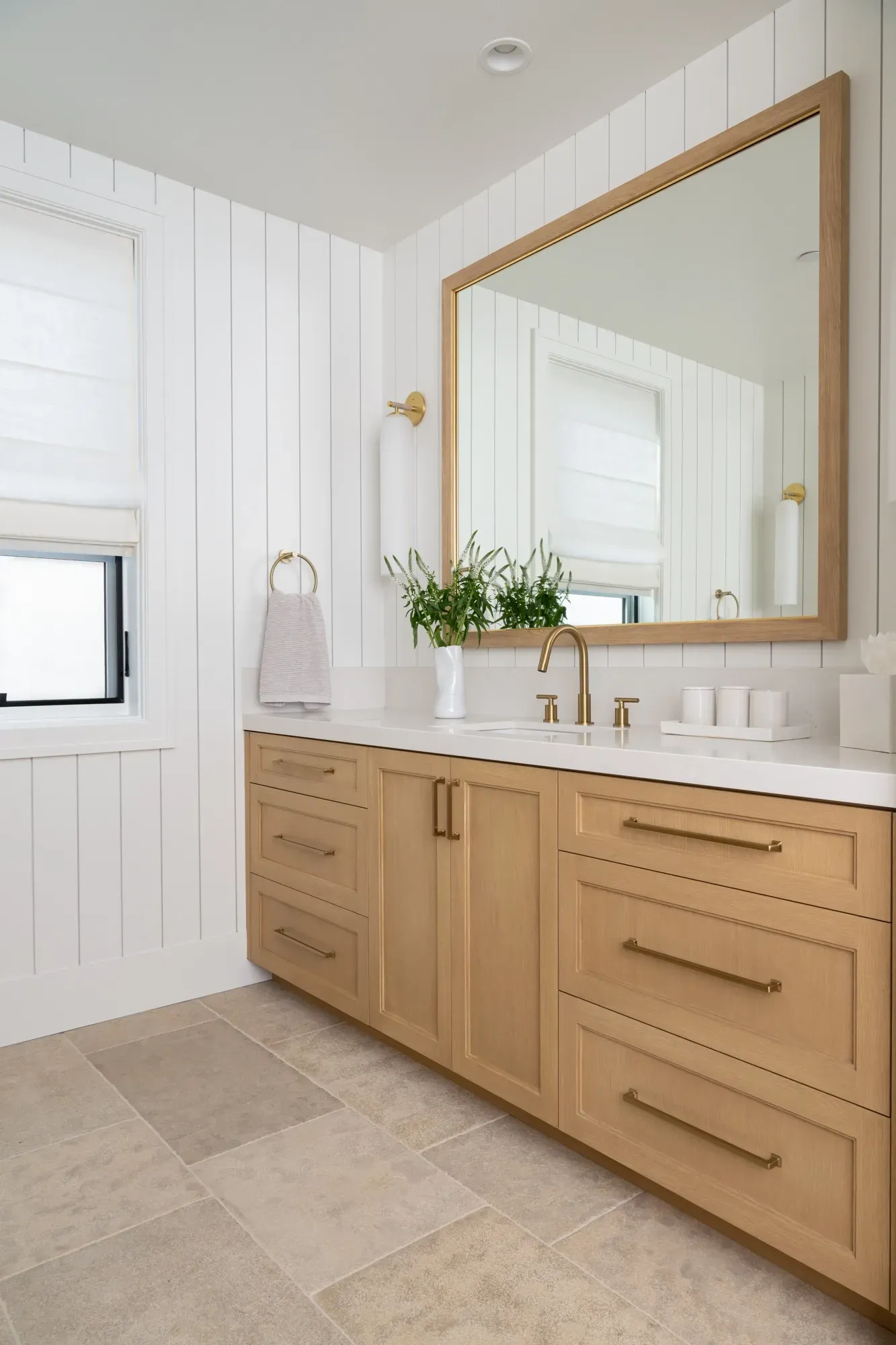 A bathroom with two sinks and a large mirror.