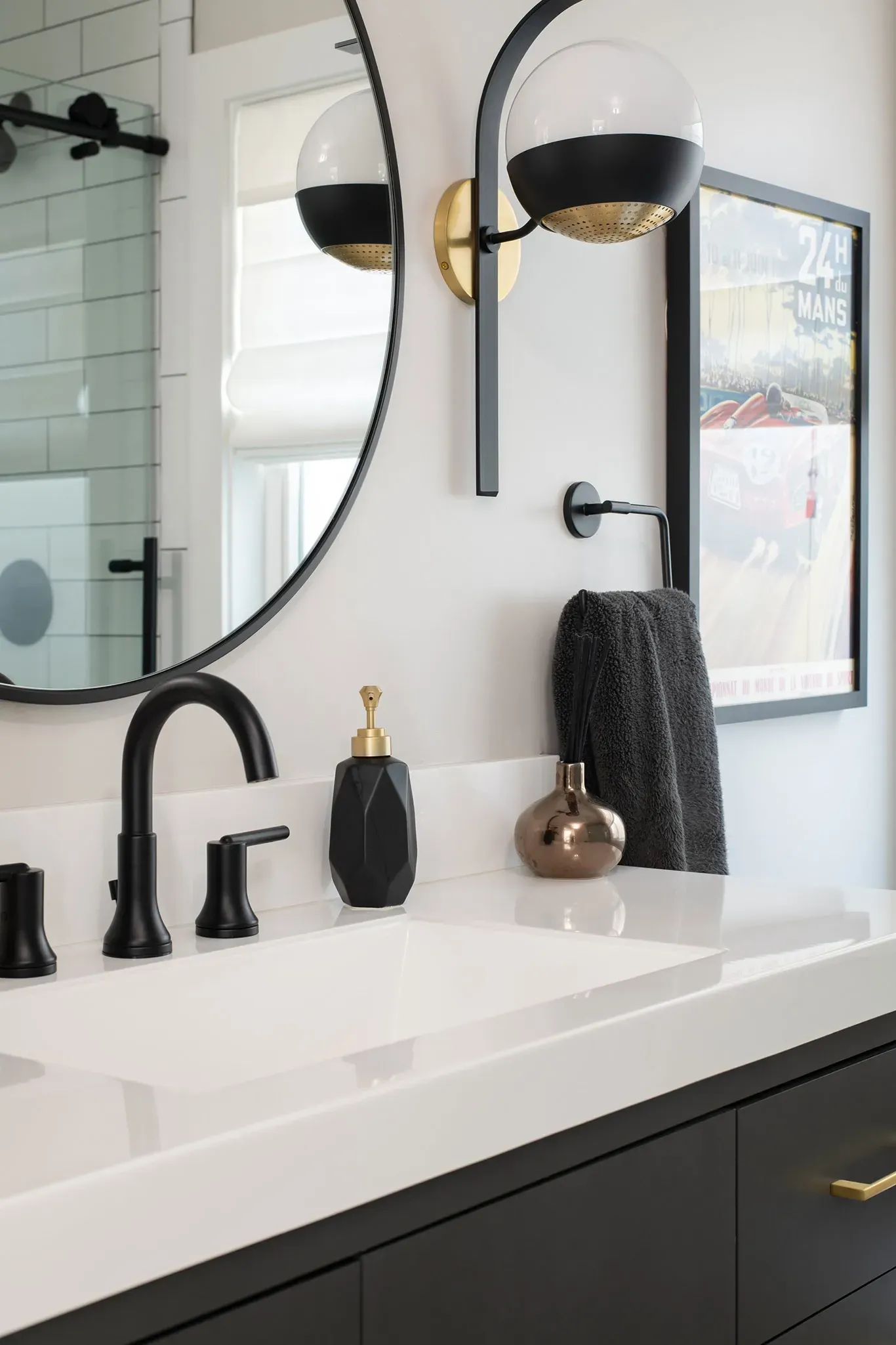 A bathroom with a sink , mirror and soap dispenser.