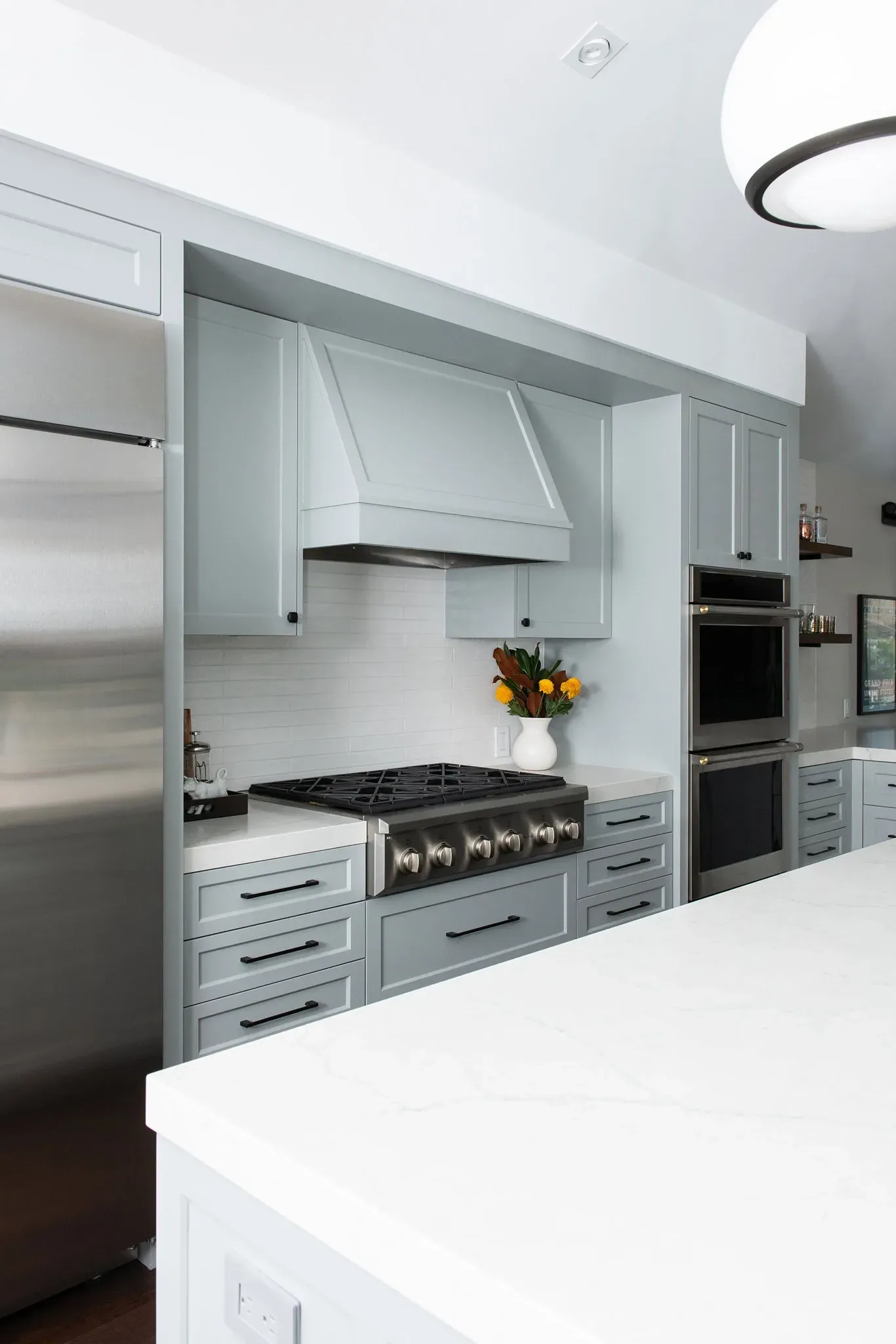 A kitchen with stainless steel appliances and white cabinets