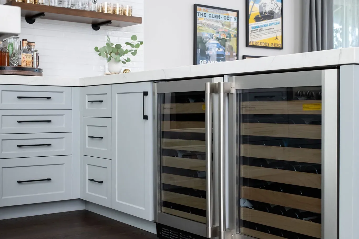 A kitchen with white cabinets and a stainless steel wine cooler.