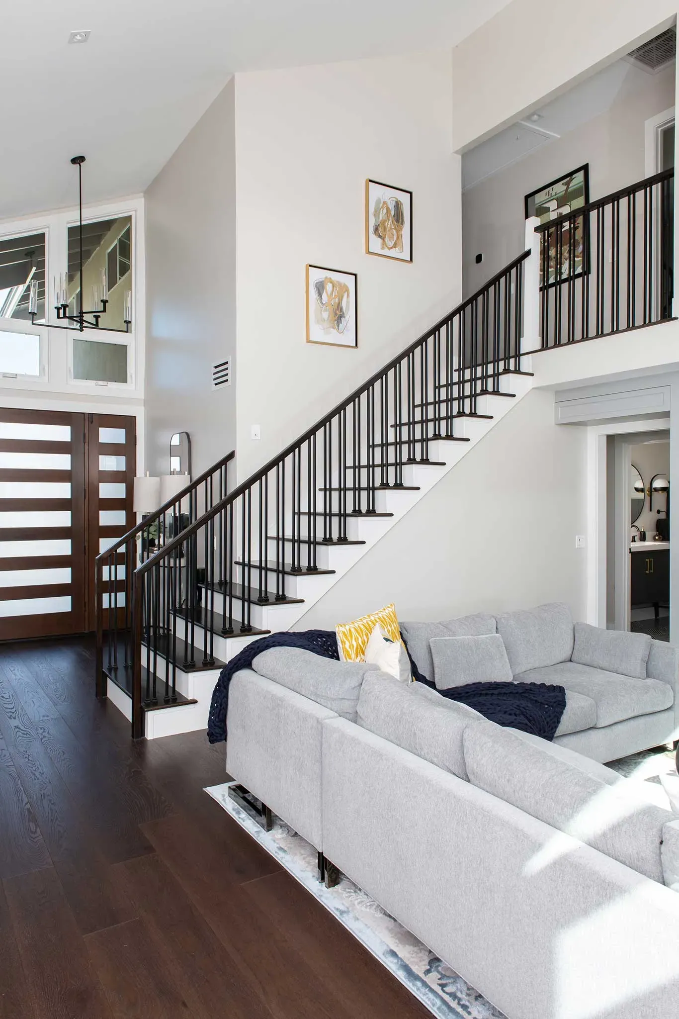 A living room with a staircase leading up to the second floor