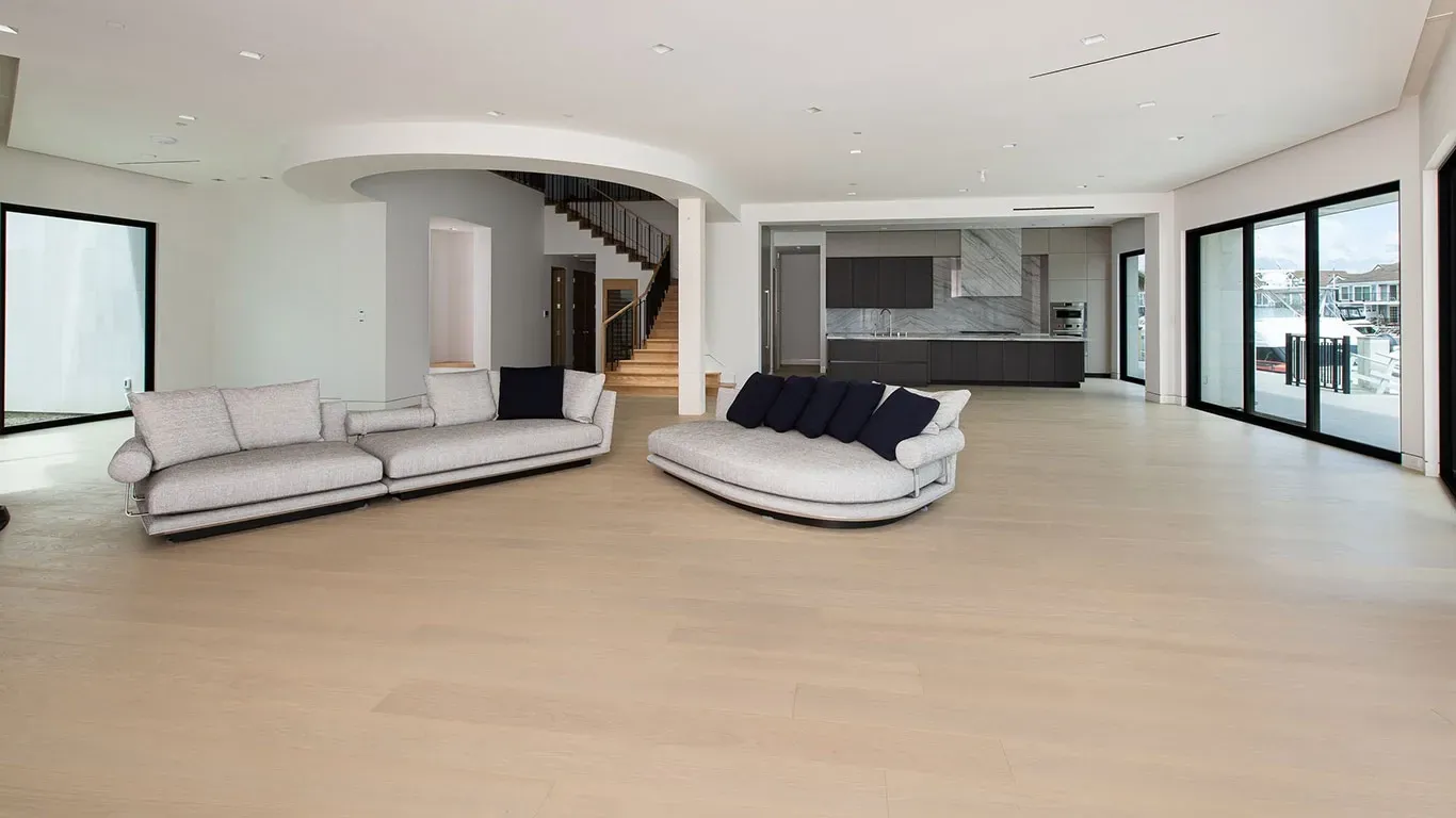 A living room with two couches and a large window.