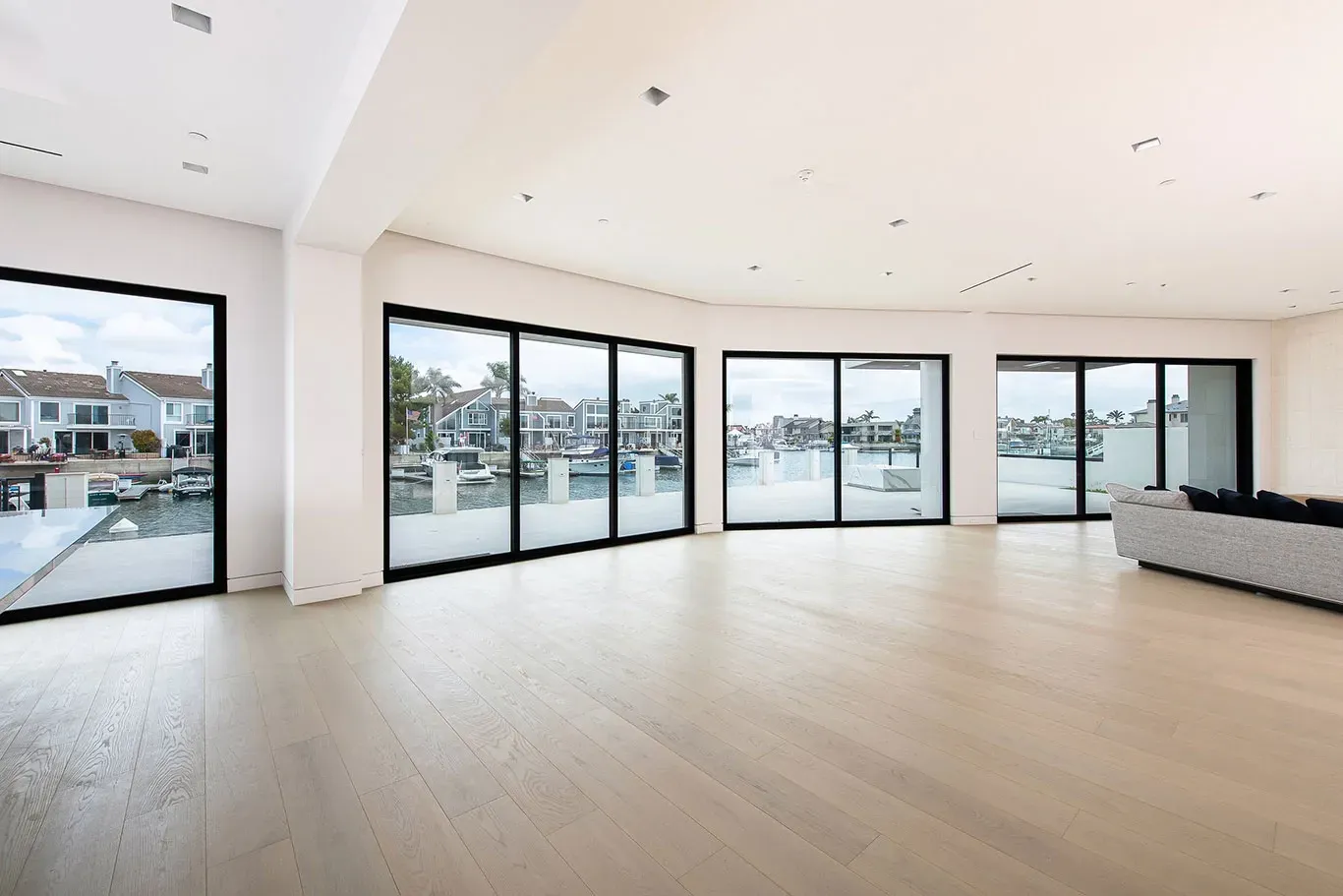 A living room with a lot of windows and a couch