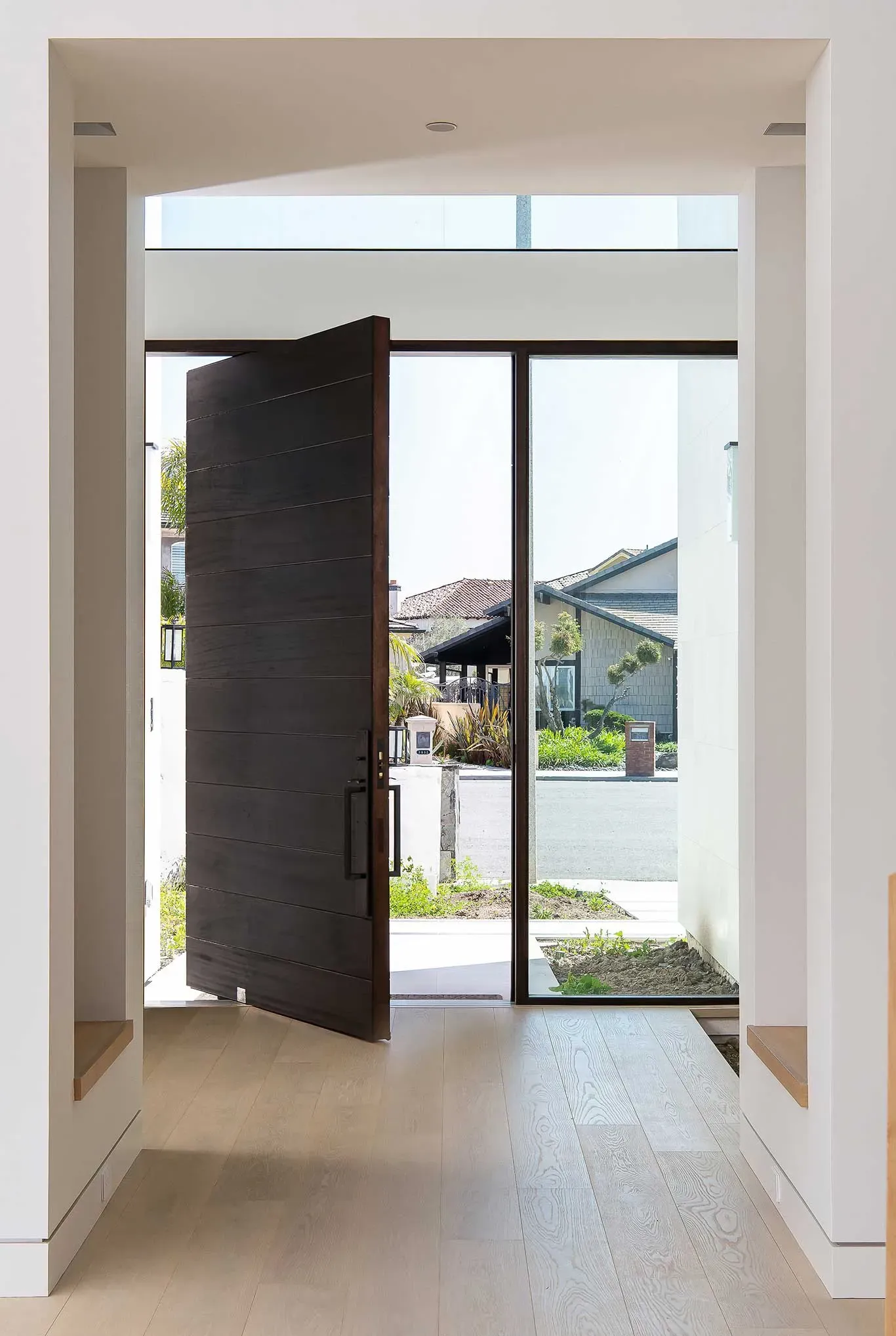 A door is open in a hallway in a house.