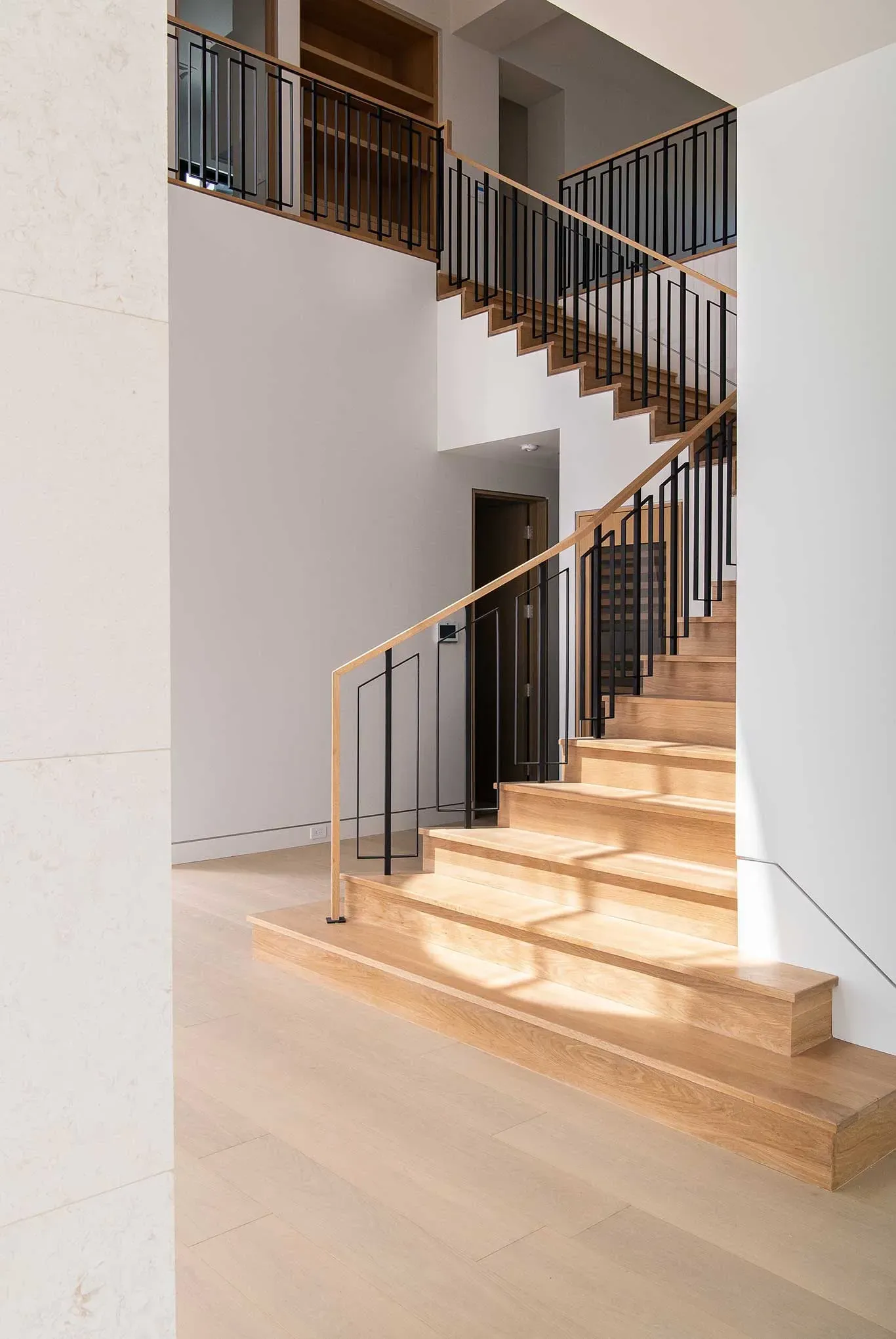 The stairs are made of marble and have a metal railing.