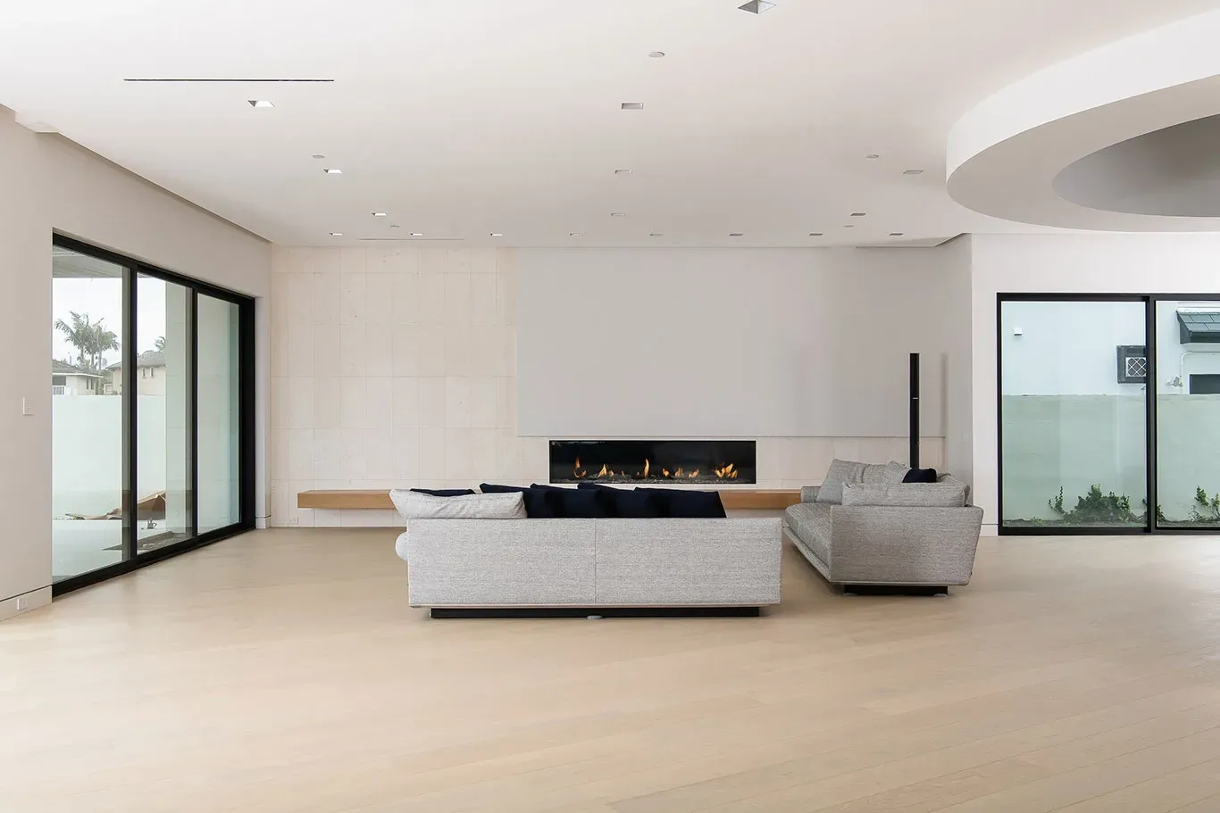 A living room with a couch , fireplace , and sliding glass doors.